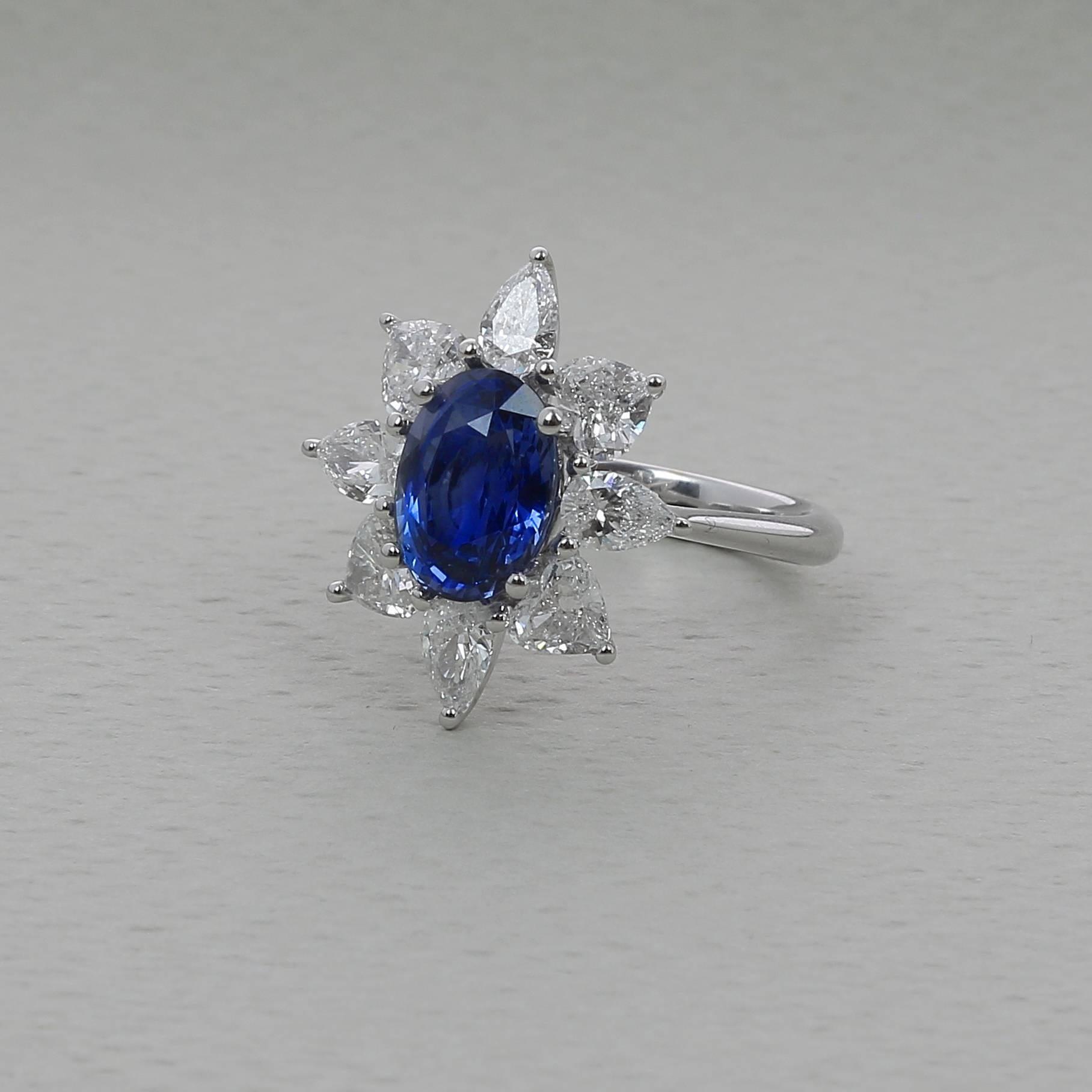 A Blue Sapphire Ring weighing 3.18 carats. The stone’s shape is oval, having for colors a Striking Blue. 
The ring is set with 4 Pear Diamonds weighing 0.83 Carats and 4 Heart Diamonds weighing 1.08 Carats.
The Sapphire comes with a GRS (Number