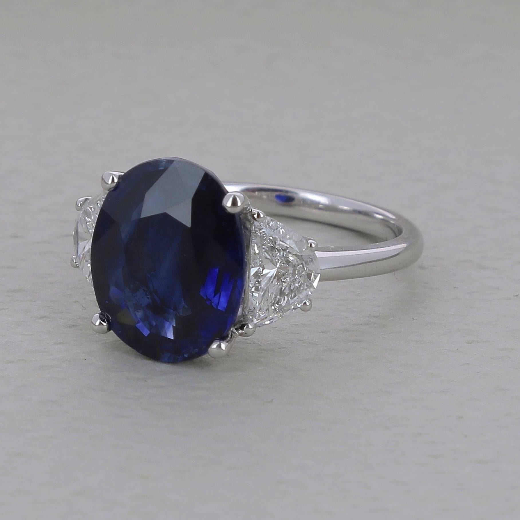 A Deep blue Sapphire Ring weighing 6.19 carats. The stone’s shape is oval, having for colors a striking deep blue. 
The ring is set with two Half Moon Diamond weighing 1.23 carats. 
The Sapphire is accompanied by a GRS certificate (Number