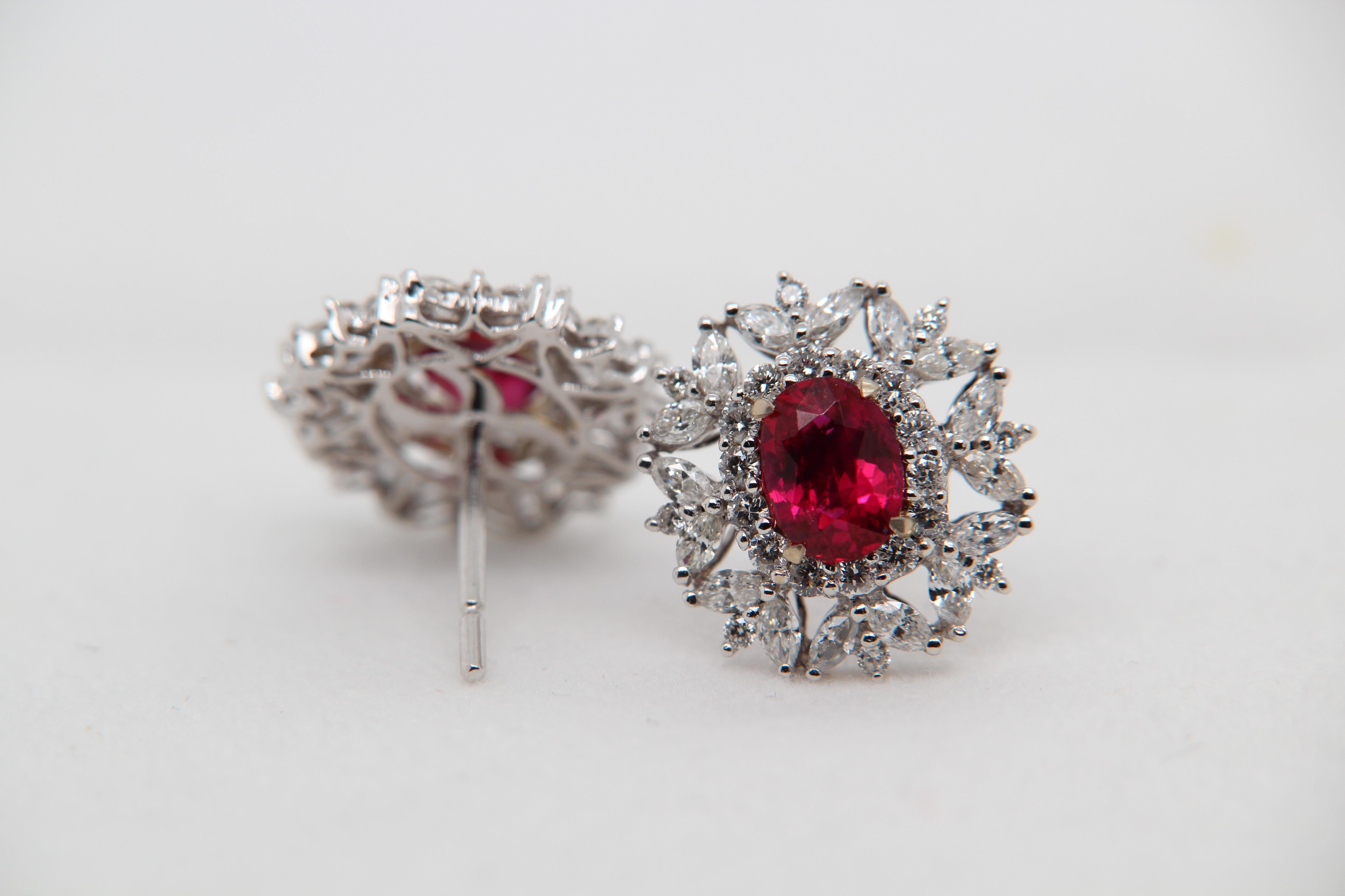 A new 2.09 carat Burmese ruby earring mounted with diamonds in 18 Karat gold. The ruby weighs 1.05 and 1.04 carats and are certified by Gem Research Swisslab (GRS) as natural, no heat, and 'Vivid Red Pigeon's Blood'. The total diamond weight is 1.61
