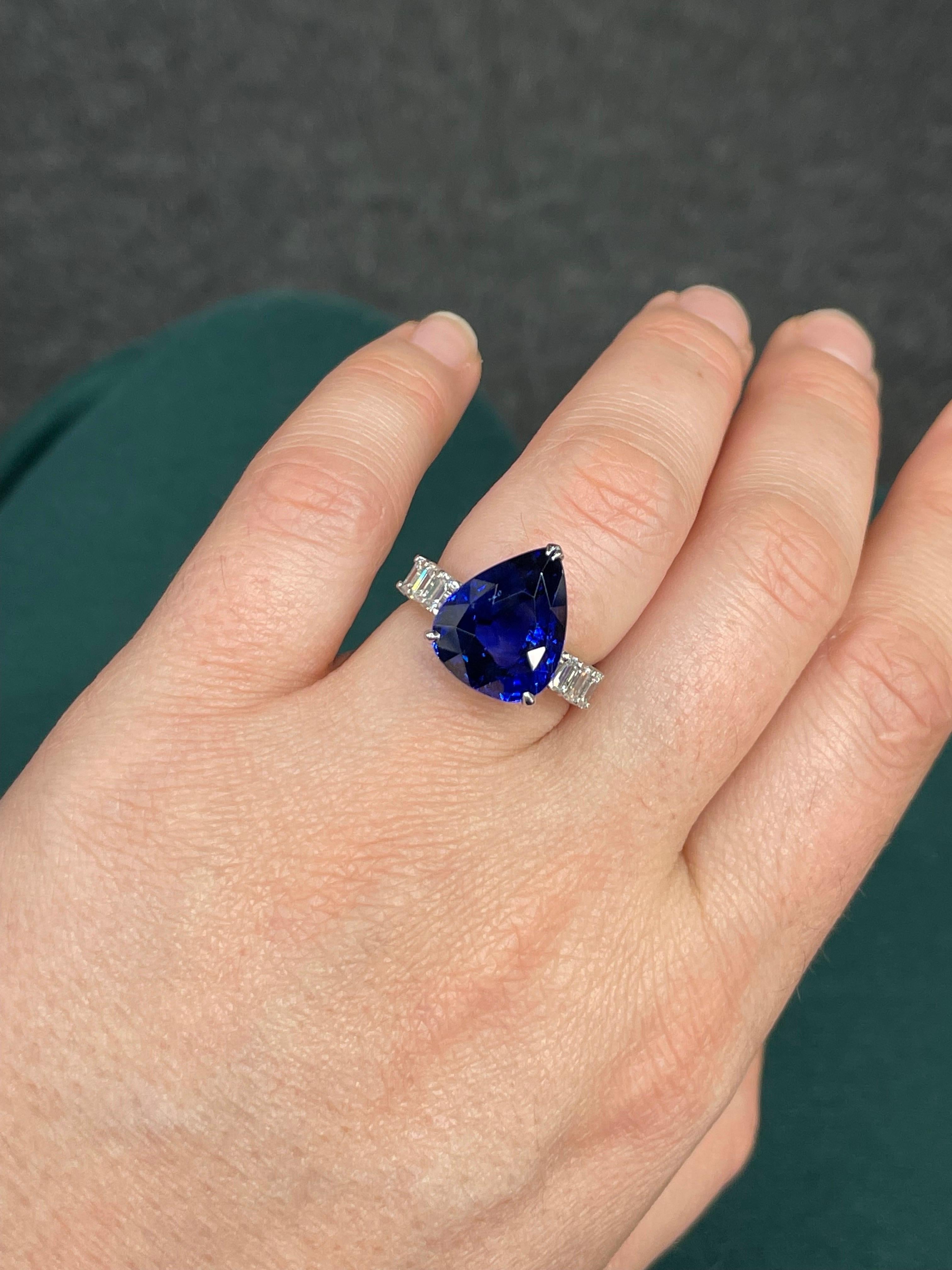 GRS Certified Pear shape natural Sapphire weighing 10.65 Carats, Vivid Blue, flanked with 6 emerald cut diamonds weighing 1 carat. 