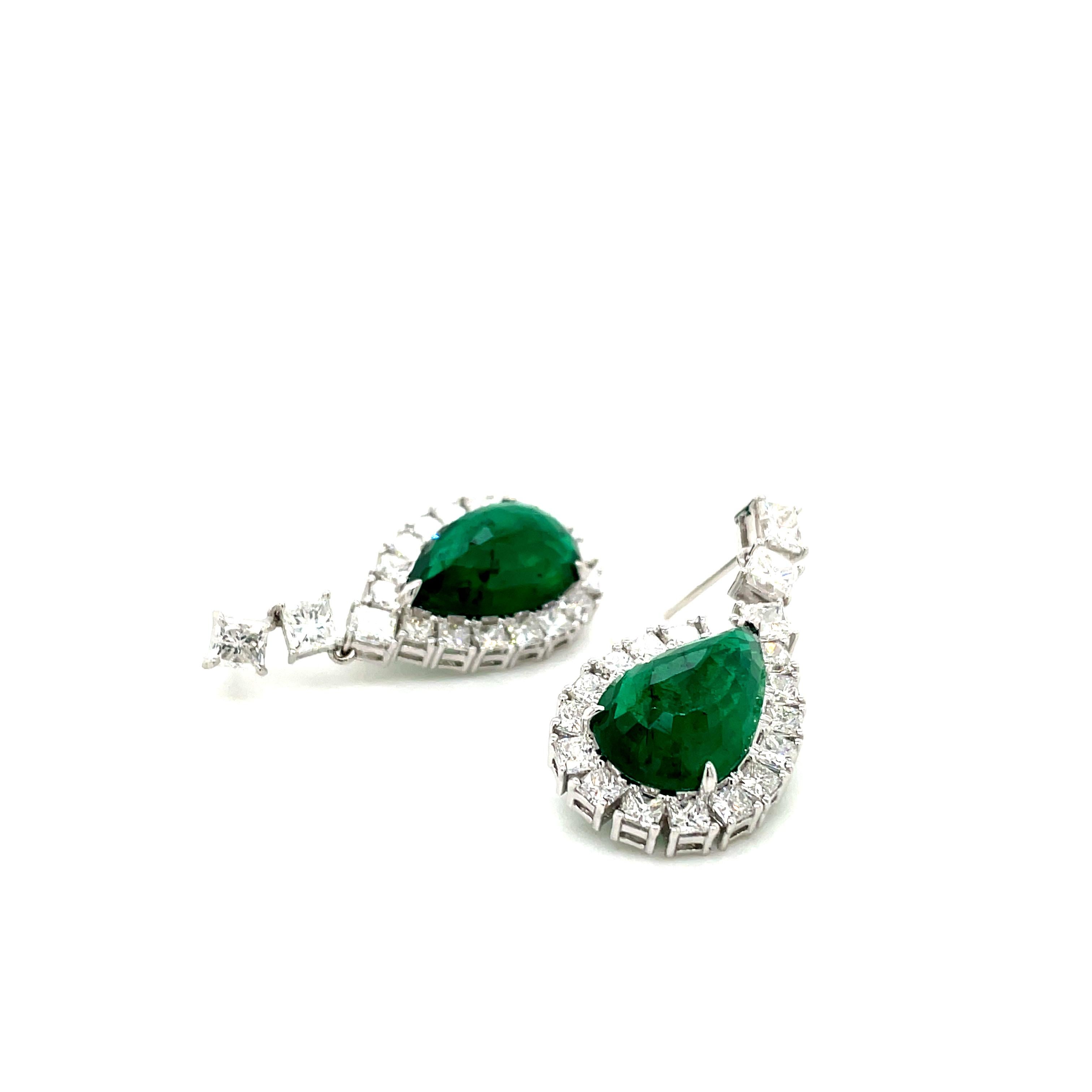 A lush green elegance meets radiant sparkle in a symphony of luxury. 

Crafted with precision and passion, these earrings boast GRS certified two pear-shaped emeralds from the renowned mines of Zambia, totaling a remarkable 10.85 carats, surrounded