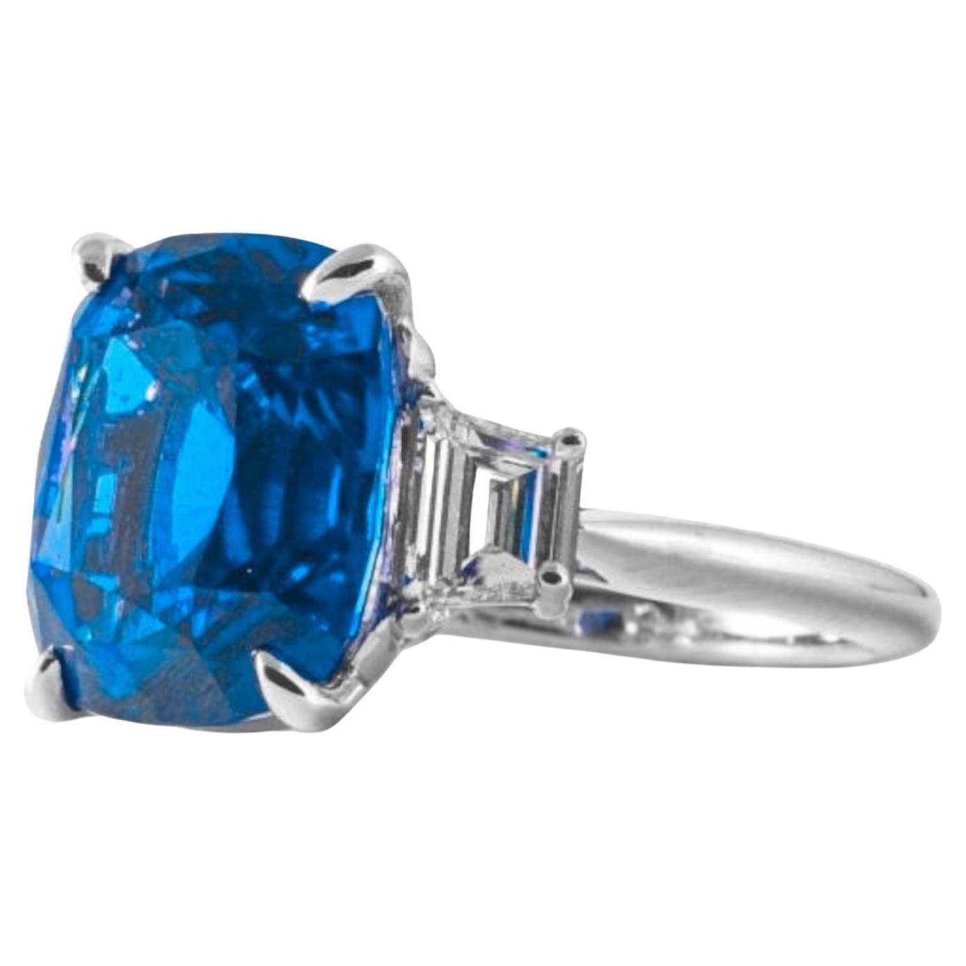 3.67-carat blue sapphire, certified by GRS and set in a classic cushion cut. Adorned with tapered baguette diamonds and crafted in luxurious platinum, this ring epitomizes elegance and sophistication. Perfect for making a statement, it combines the