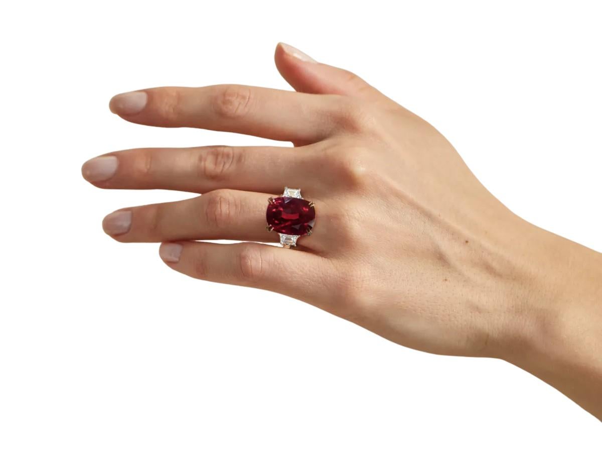 Introducing the exquisite GRS No Heat Certified 5.05 Carat Ruby Cushion Diamond Ring, adorned with trapezoid diamonds on the sides. At the heart of this remarkable ring lies a captivating cushion-cut ruby, certified by GRS for its exceptional