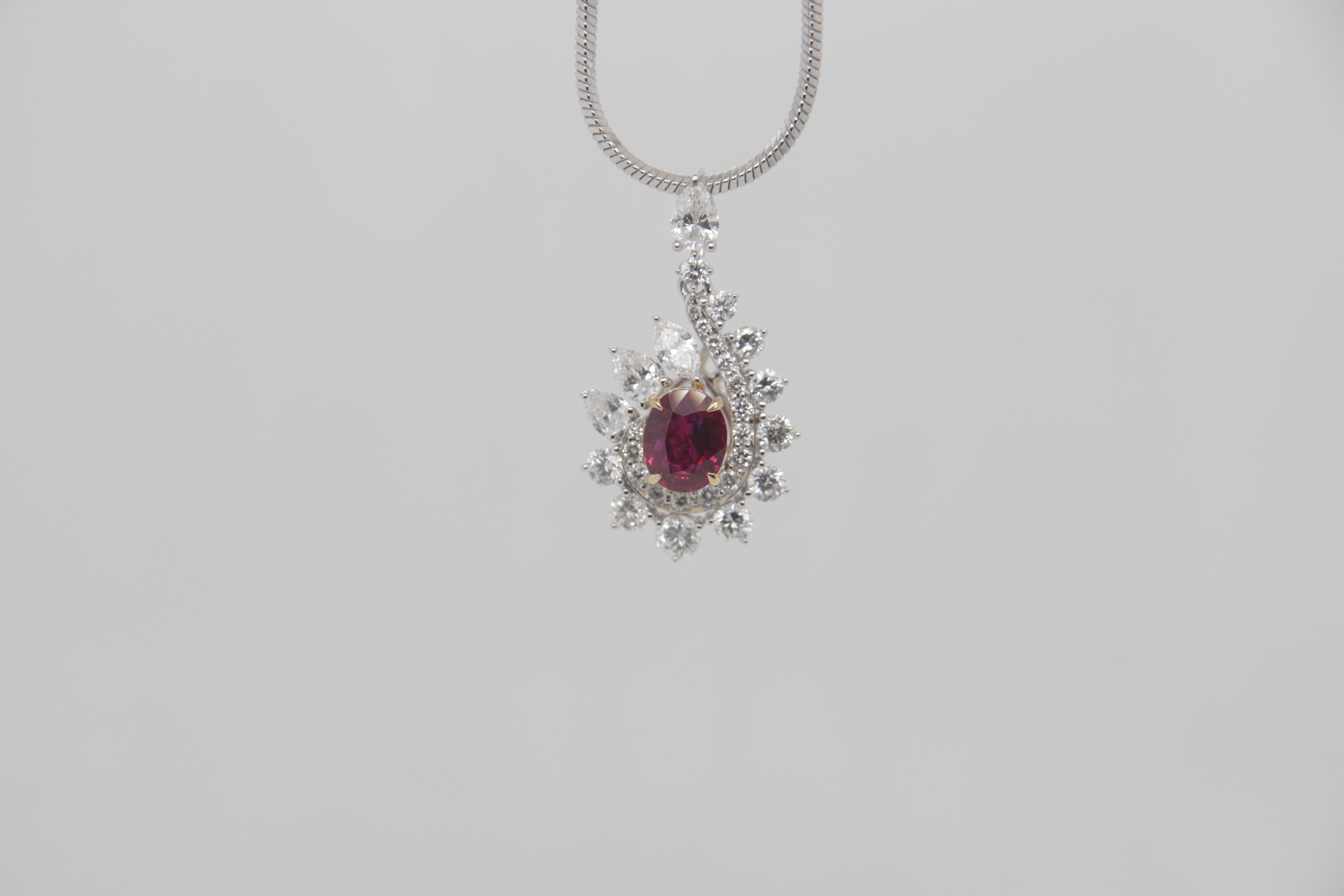 A brand new 0.74 carat Burmese ruby pendant mounted with diamonds in 18 Karat gold. The ruby weighs 0.74 carat and is certified by Gem Research Swisslab (GRS) as natural, no heat, and 'Vivid Red Pigeon's Blood'. The total diamond weight is 0.86