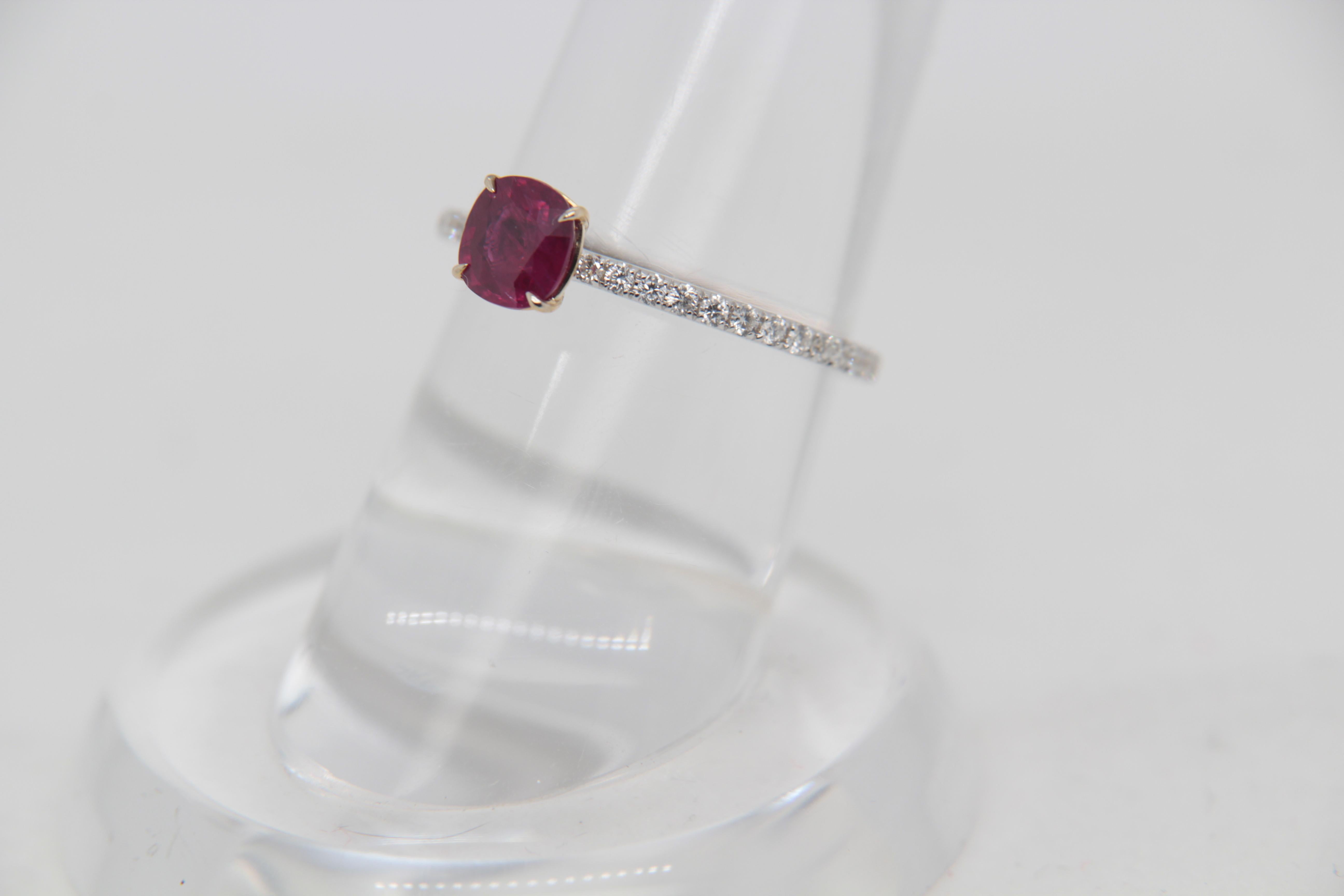 A brand new 0.86 carat Burmese ruby ring mounted with diamonds in 18 Karat gold. The ruby weighs 0.86 carat and is certified by Gem Research Swisslab (GRS) as natural, no heat, and 'Vivid Red Pigeon's Blood'. The total diamond weight is 0.29 carat