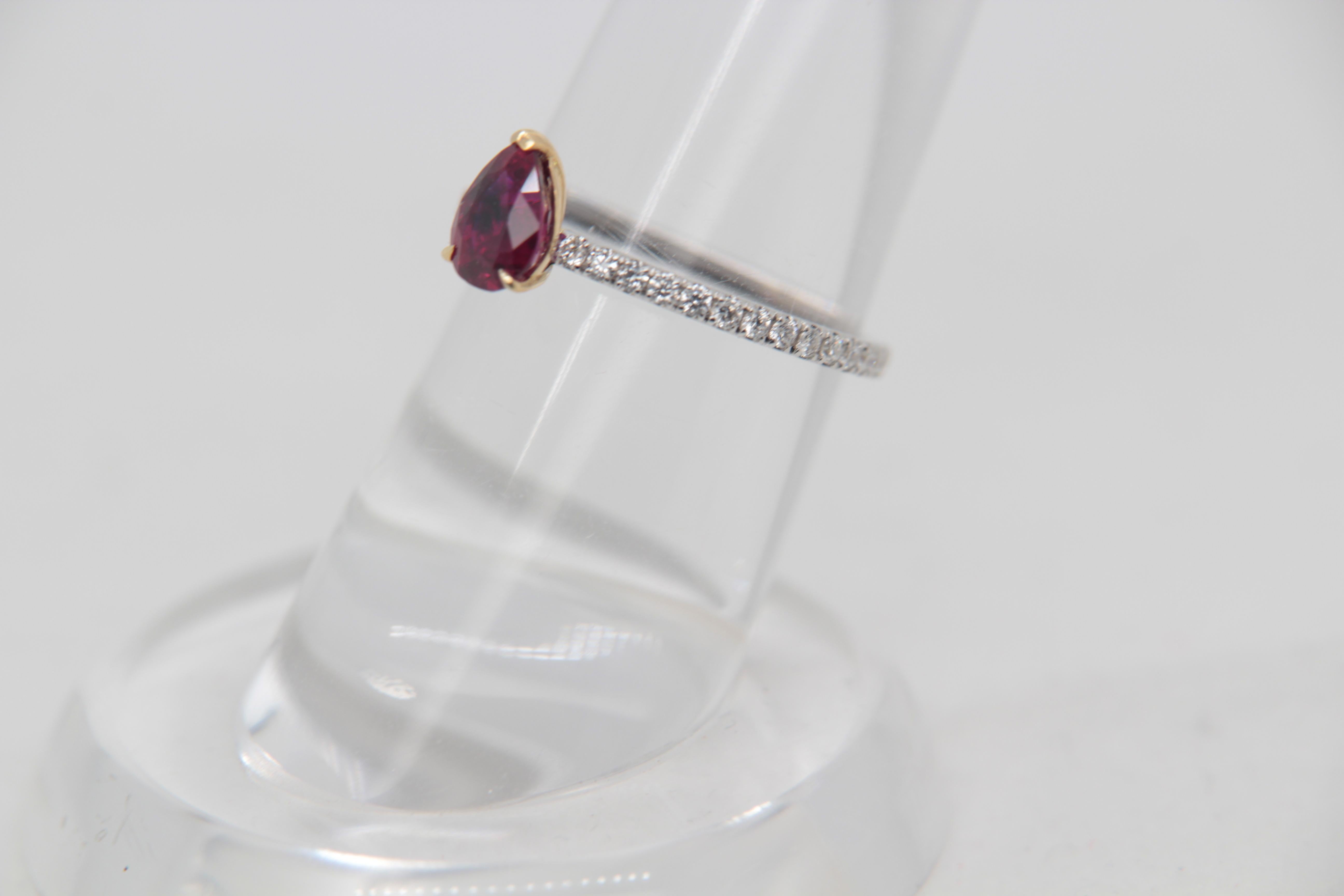 A brand new 0.96 carat Burmese ruby ring mounted with diamonds in 18 Karat gold. The ruby weighs 0.96 carat and is certified by Gem Research Swisslab (GRS) as natural, no heat, and 'Vivid Red Pigeon's Blood'. The total diamond weight is 0.30 carat