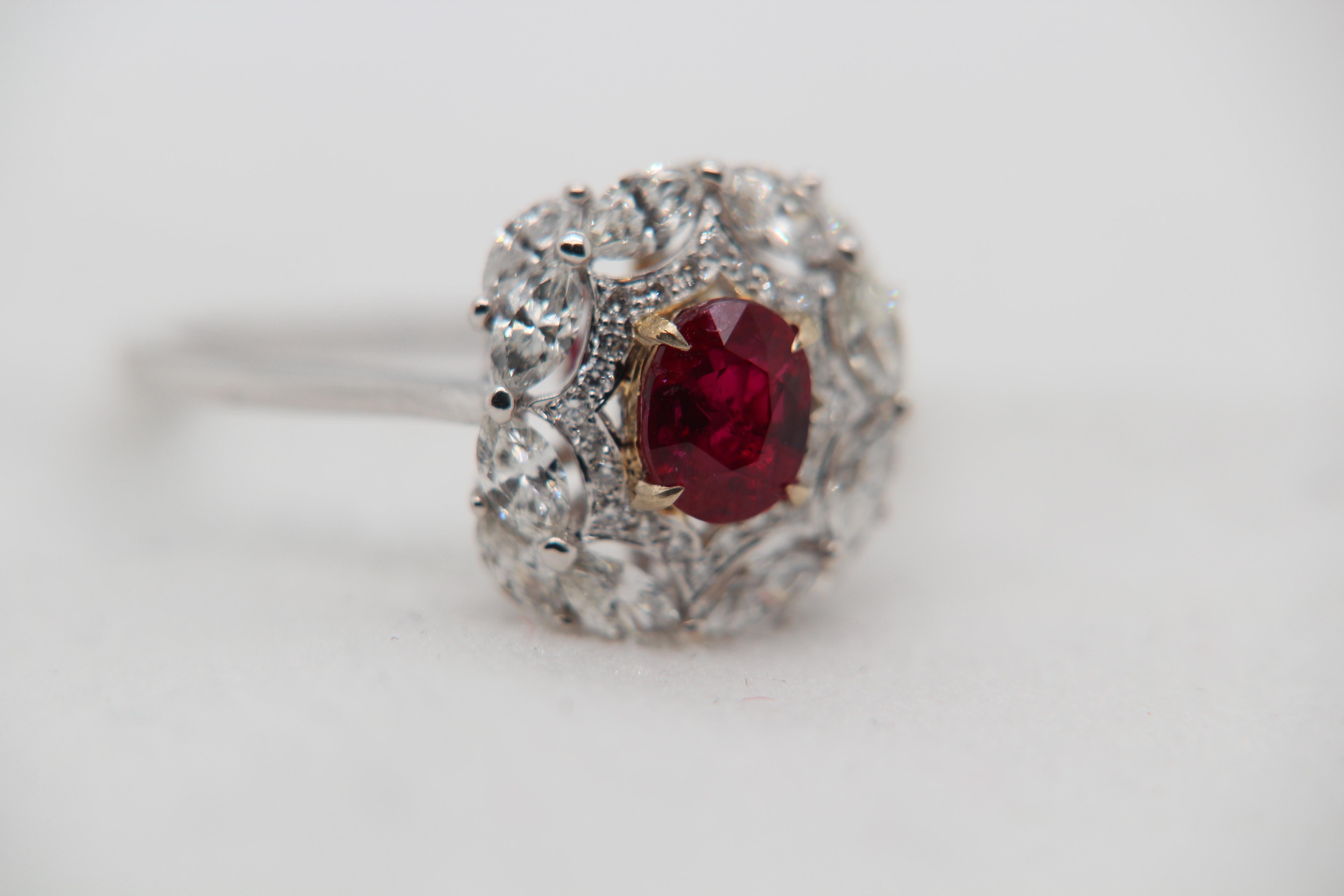 A brand new 1.02 carat Burmese ruby ring mounted with diamonds in 18 Karat gold. The ruby weighs 1.02 carat and is certified by Gem Research Swisslab (GRS) as natural, no heat, and 'Vivid Red Pigeon's Blood'. The total diamond weight is 0.90 carat