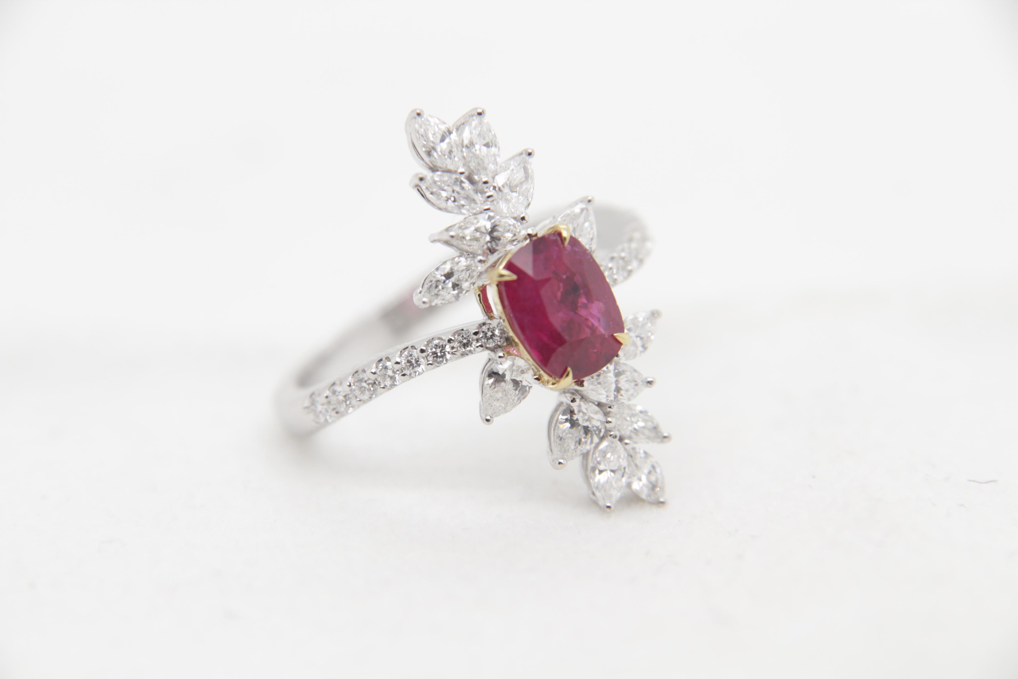 A brand new 1.13 carat Burmese ruby ring mounted with diamonds in 18 Karat gold. The ruby weighs 1.13 carat and is certified by Gem Research Swisslab (GRS) as natural, no heat, and 'Pigeon Blood'. The total diamond weight is 1.08 carat and the total
