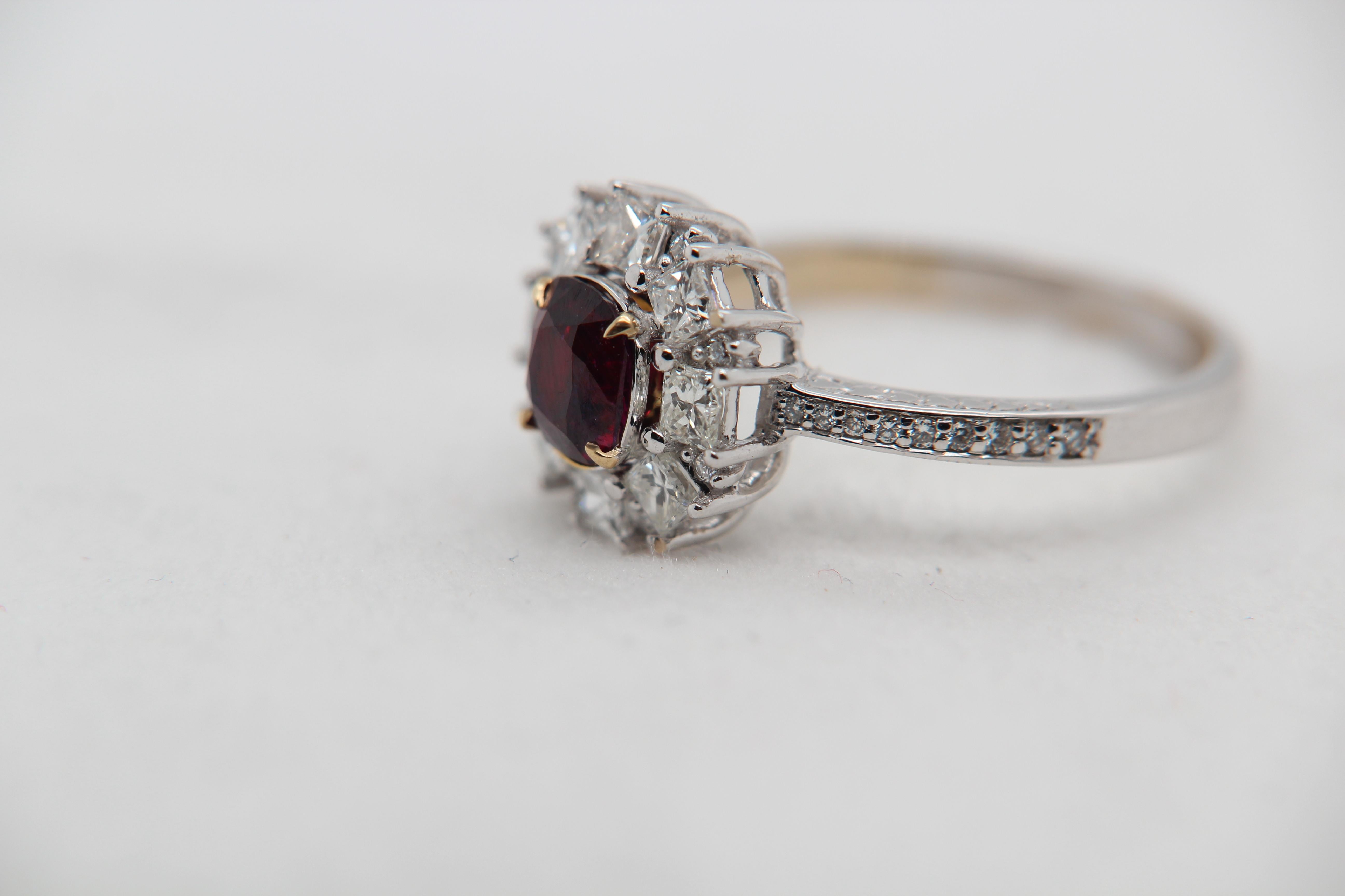 A brand new 1.29 carat Burmese ruby ring mounted with diamonds in 18 Karat gold. The ruby weighs 1.29 carat and is certified by Gem Research Swisslab (GRS) as natural, no heat, and 'Vivid Red Pigeon's Blood'. The total diamond weight is 0.93 carat