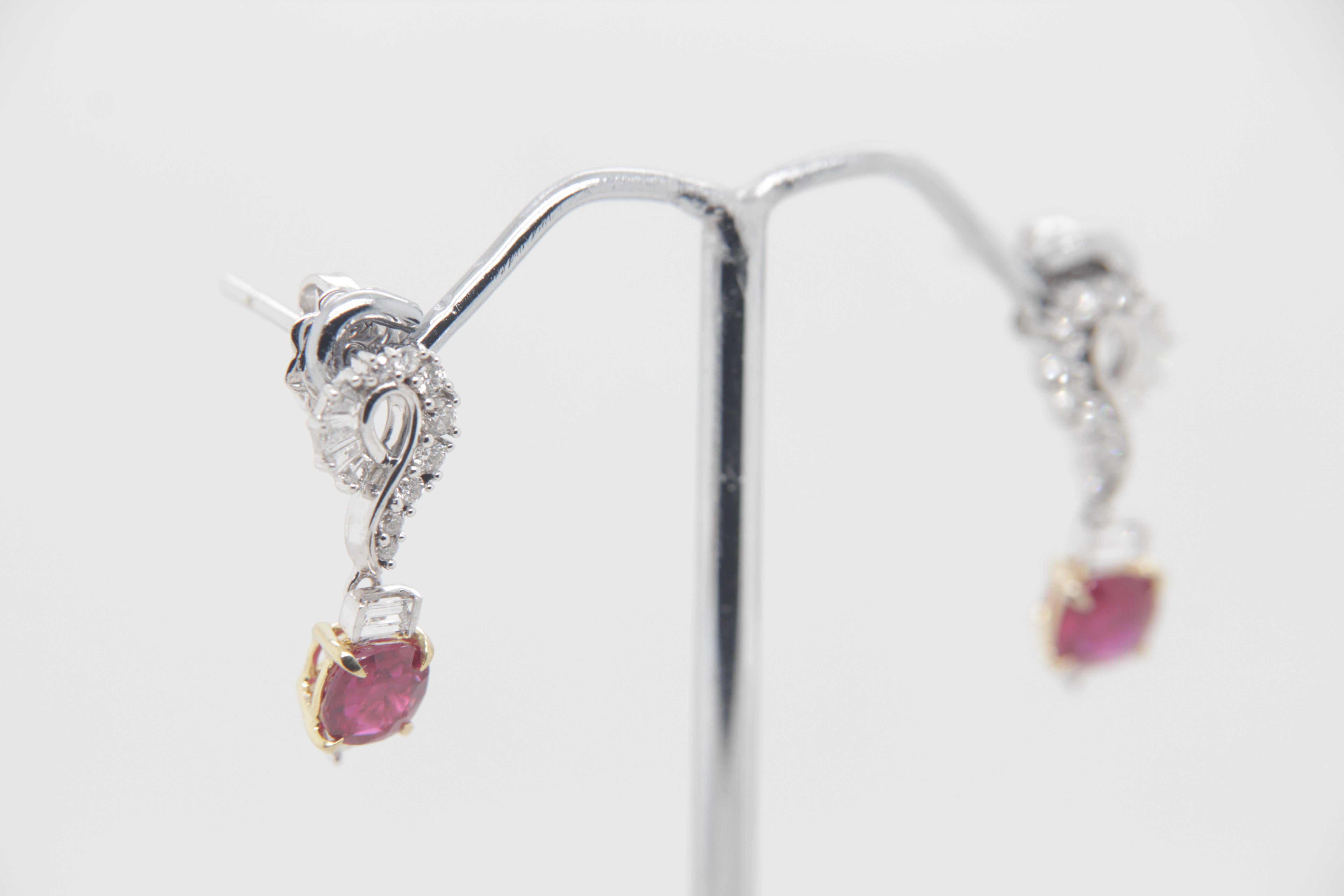 A new 1.47 carat Burmese ruby earring mounted with diamonds in 18 Karat gold. The ruby weighs 0.64 and 0.83 carats and are certified by Gem Research Swisslab (GRS) as natural, no heat, and 'Vivid Red Pigeon's Blood'. The total diamond weight is 0.48