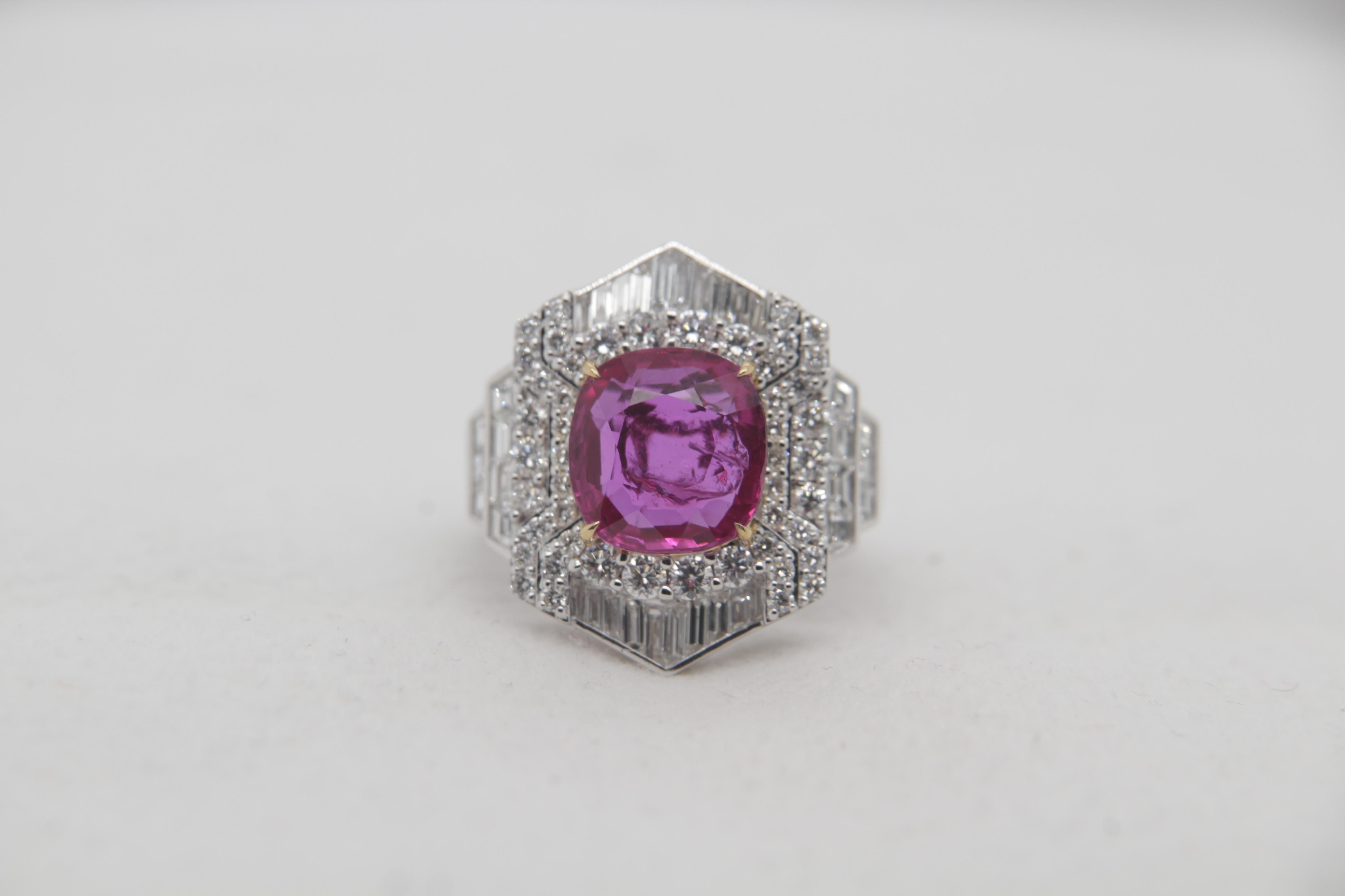 A brand new 4.23 carat Burmese ruby ring mounted with diamonds in 18 Karat gold. The ruby weighs 4.23 carat and is certified by Gem Research Swisslab (GRS) as natural, no heat, and 'Red'. The total diamond weight is 1.76 carat and the total rings