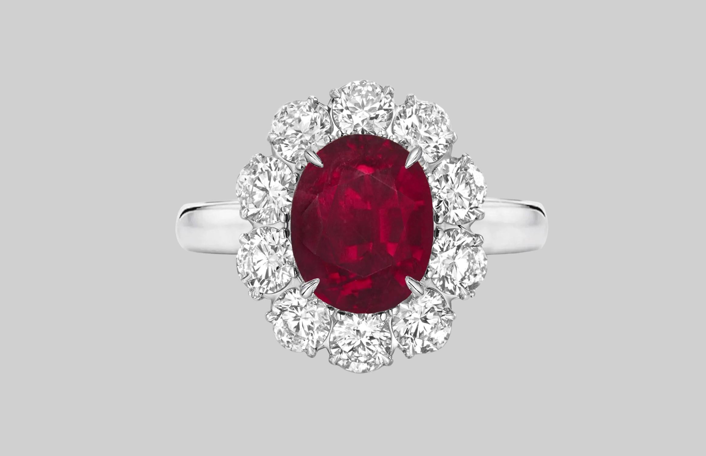 An exquisite 5 carat vivid blood red purple oval no-heat ruby commands attention in this extraordinary 18 carats yellow gold and platinum classic ring.

 A halo of approximately 1.50 carats of bright white (E/F) and (VS) diamonds encircle the