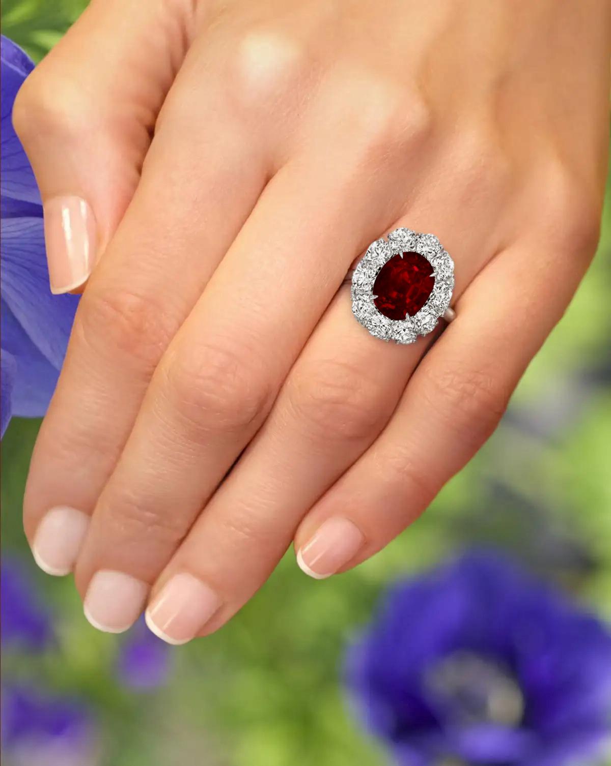 An exquisite 5 carat vivid blood red purple oval no-heat ruby commands attention in this extraordinary 18 carats yellow gold and platinum classic ring.

 A halo of approximately 1.50 carats of bright white (E/F) and (VS) diamonds encircle the