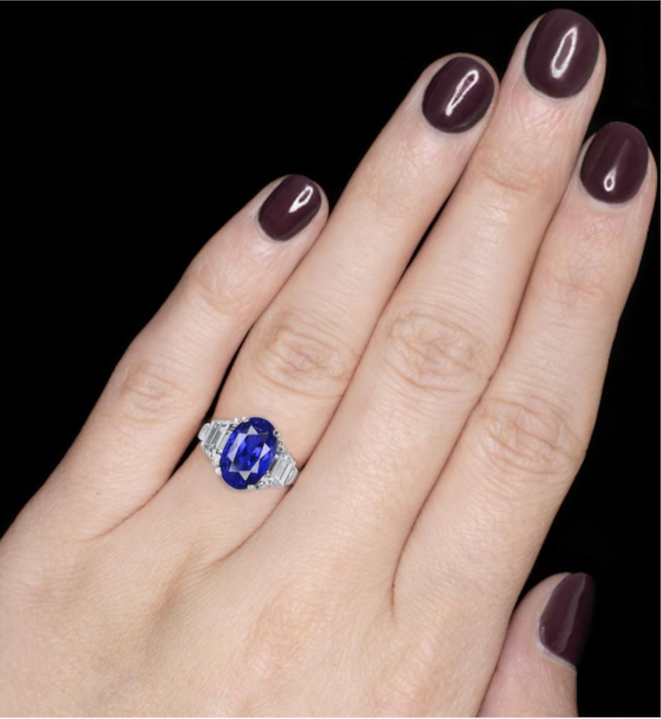 Featuring an exquisite vivid untreated unheated blue Ceylon oval-shaped sapphire flanked by trapezoid-shaped diamonds.

Blue sapphire weighing 5.12 carats
Diamonds weighing 2 carats
Size 7 1/2
Platinum
Accompanied by GRS REPORT