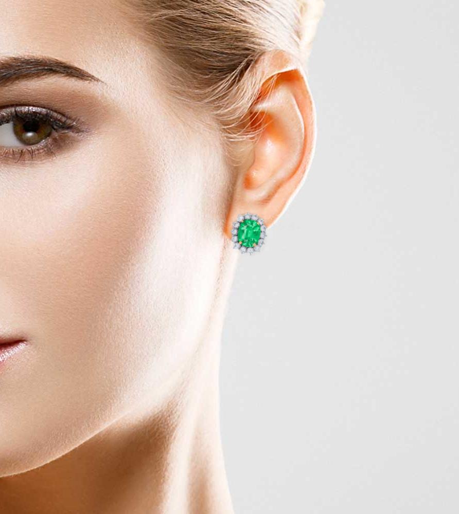 Handmade in Italy this diamond halo earrings with large cushion cut green emeralds 
Green emerald cushion cut stones are certified as insignificant minor oil 
Round brilliant cut white diamonds are 1 ct in total.
Diamonds are all natural and white