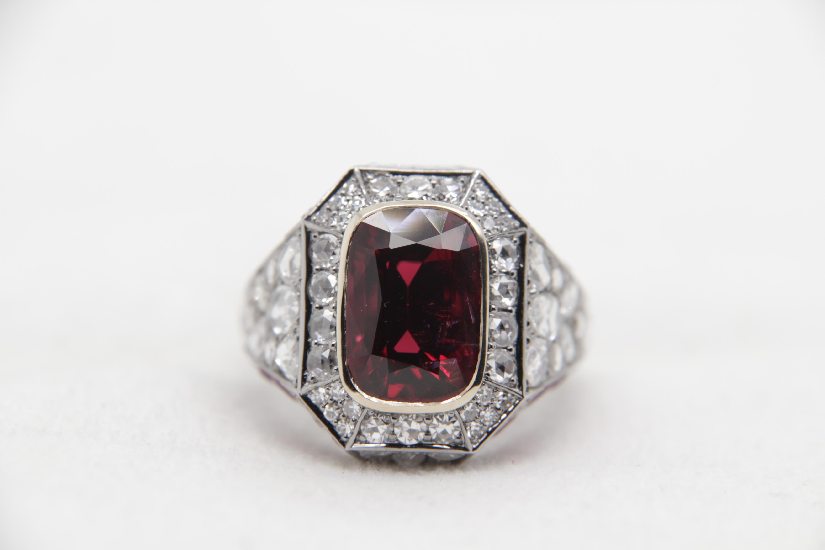 A brand new spinal, ruby and diamond ring in 18 K gold. The spinal weighs 5.28 carats and is certified by Gem Research Swisslab (GRS) as natural, no heat, and 'Vivid Red'. The total ruby weight is 1.86 carats and diamond weight is 1.88 carats. The