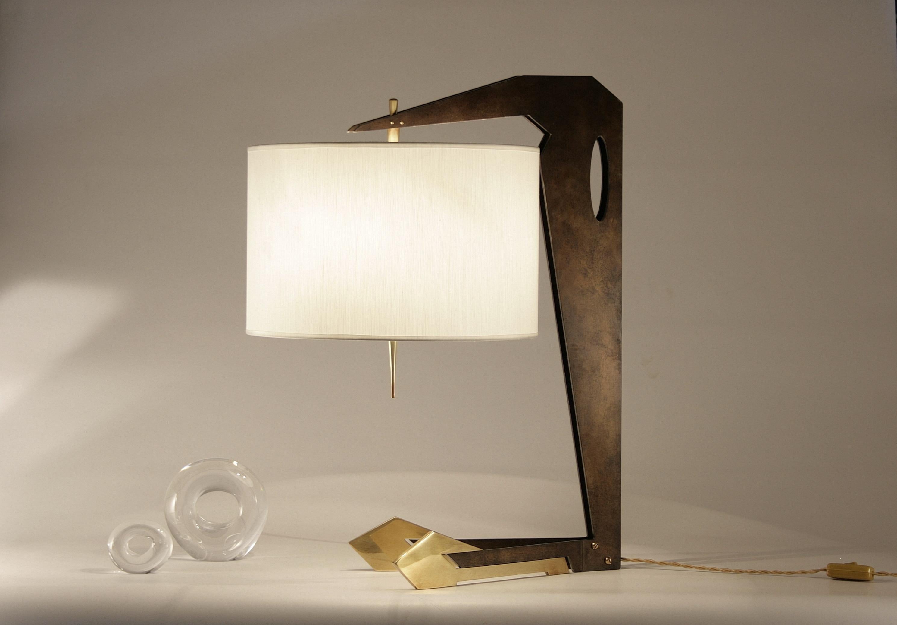 Lamp with metal structure composed of natural waxed iron and slightly burnished brass. Circular lampshade in ivory colored shantung; brass details.