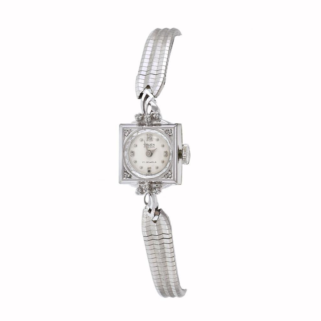 Introducing the Gruen 1950's Ladies Cocktail Watch, a timeless blend of elegance and sophistication. Encased in a 14x14mm 14KT White Gold Square Case, this exquisite timepiece exudes luxury and refinement. Its White Dial, adorned with Silver