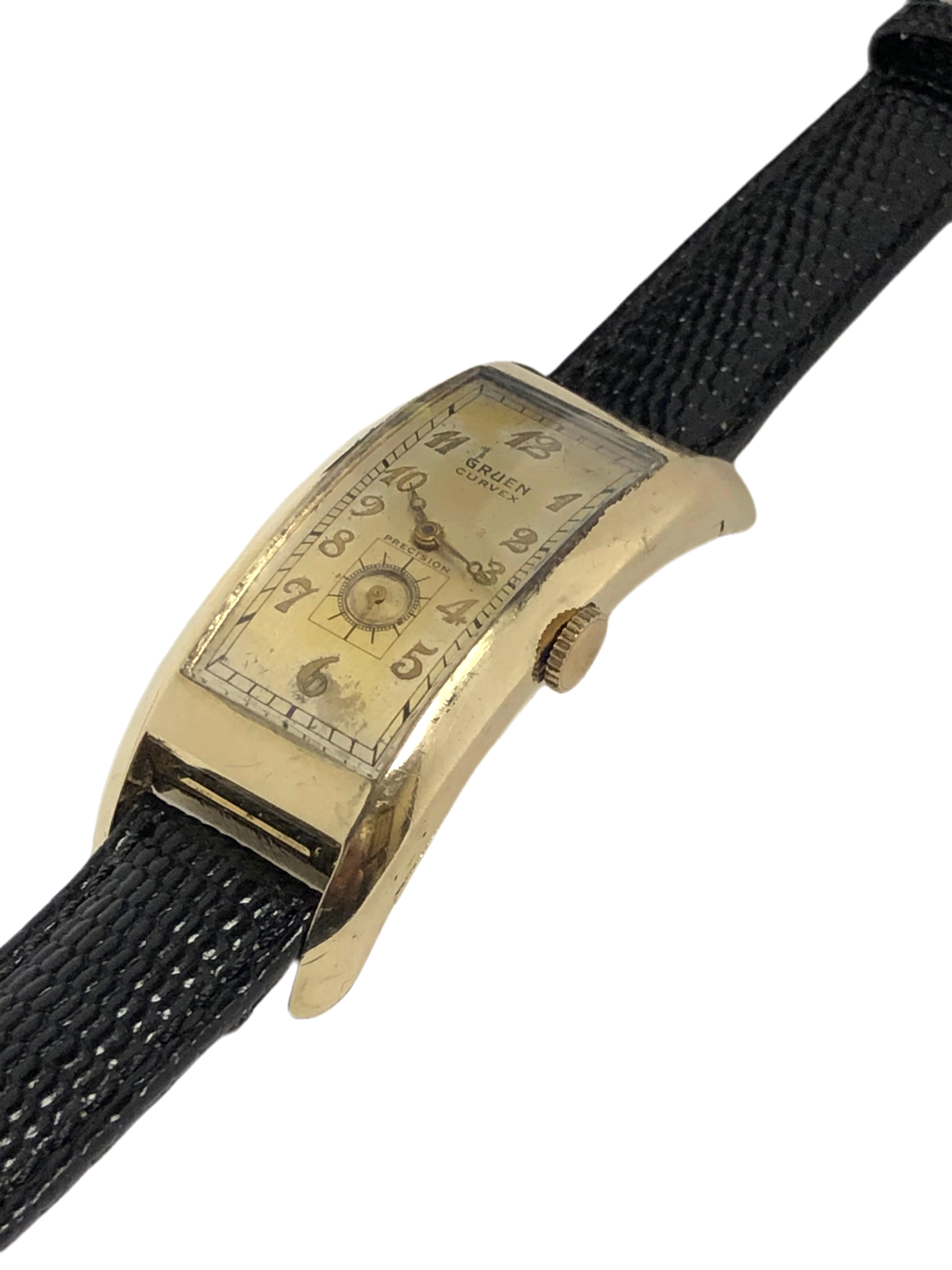Circa 1939 Gruen Curvex Majesty Wrist Watch, 52 M.M. extreme curved Yellow Gold Filled 2 Piece case. Caliber 330 Manual wind movement, original silvered dial with raised markers and a sub seconds hand. The face shows some fading but is a very good