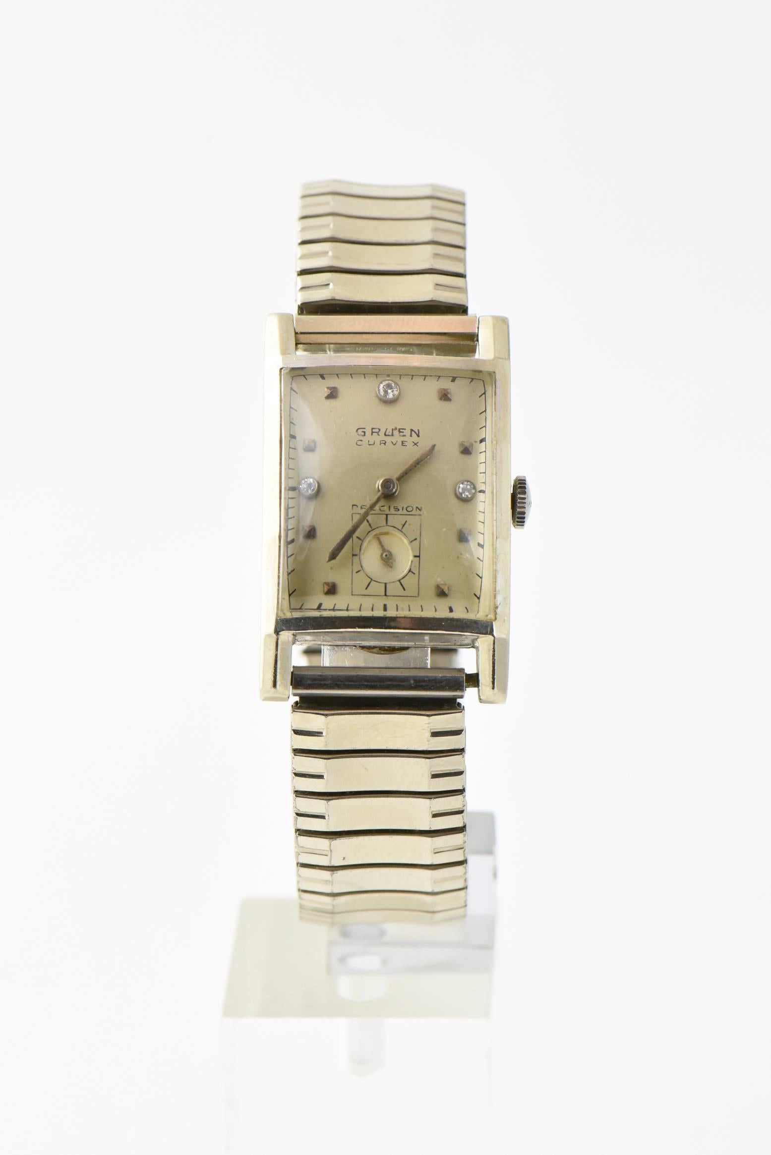 Late-1940s Gruen Curvex Precision 14K white gold men's watch on a flexible steel Speidel band. Three diamonds on the watch face. Mechanical - wind movement. The back of the case is marked: 14K WBO GOLD. Serial number: 344420. Age wear.