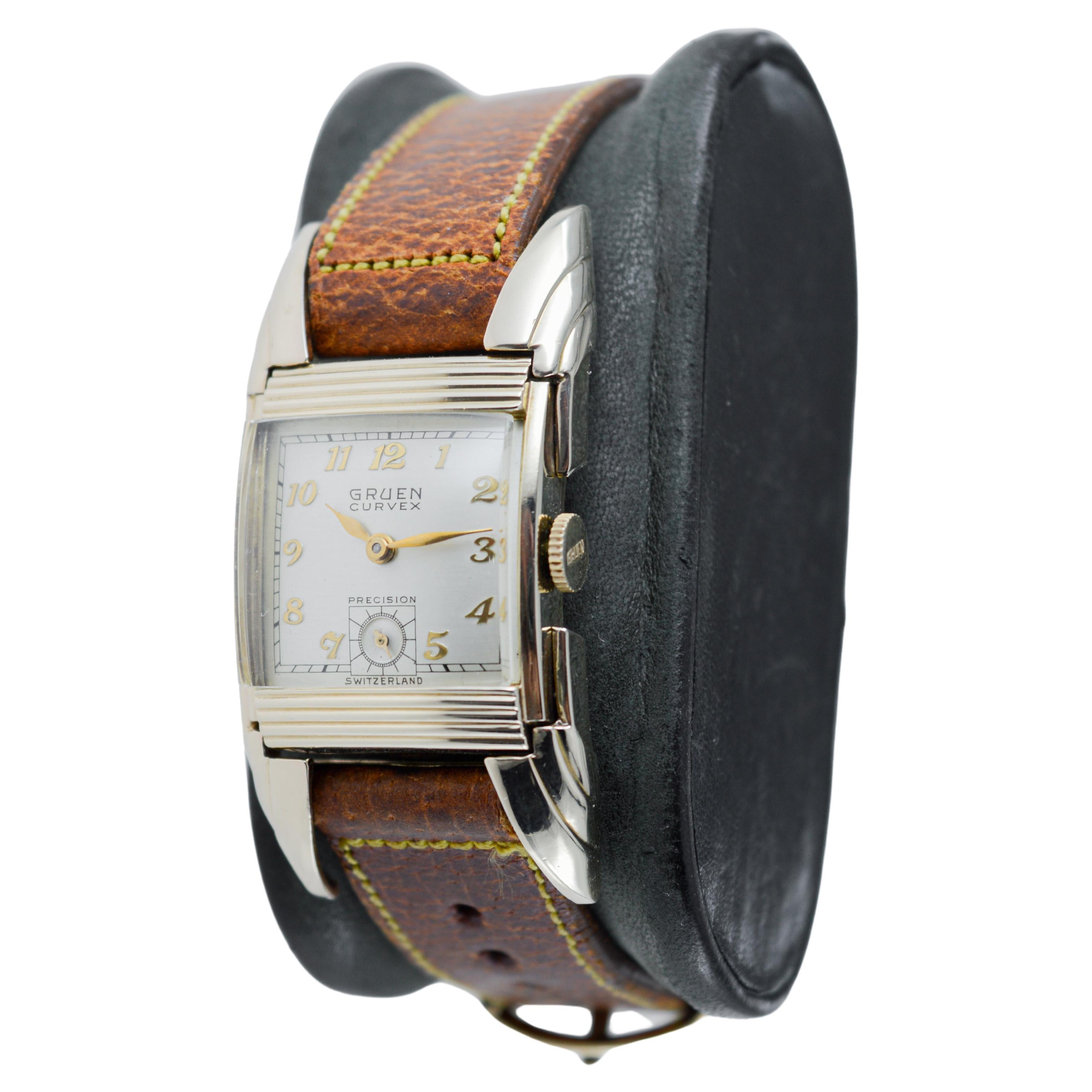 FACTORY / HOUSE: Gruen Watch Company
STYLE / REFERENCE: Ristside or Batwing 
METAL / MATERIAL: Yellow Gold-Filled
CIRCA / YEAR: 1950
DIMENSIONS / SIZE: 23mm Length X 47mm Width
MOVEMENT / CALIBER: Manual Winding / 17 Jewels / Caliber 440 
DIAL /