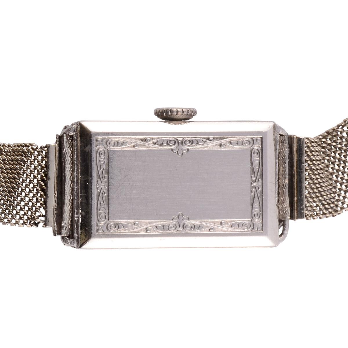 Vintage Swiss Gruen platinum diamond and sapphire wrist watch, circa 1925. This Art Deco ladies wrist watch has 1.25 carat total weight diamonds, VS clarity, F-G color and French cut sapphires along with an 18 karat white gold heavy mesh band. It