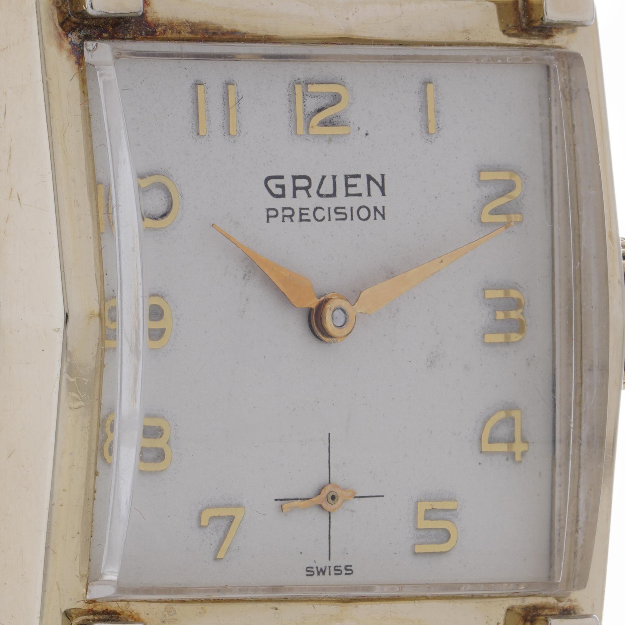 This vintage Gruen Precision wristwatch features a 9kt gold case with a stainless steel back The watch is powered by a manual movement and showcases a rectangular dial with gold-tone numerals and elegant hands. 

Key Points:
Material: 9kt gold case,
