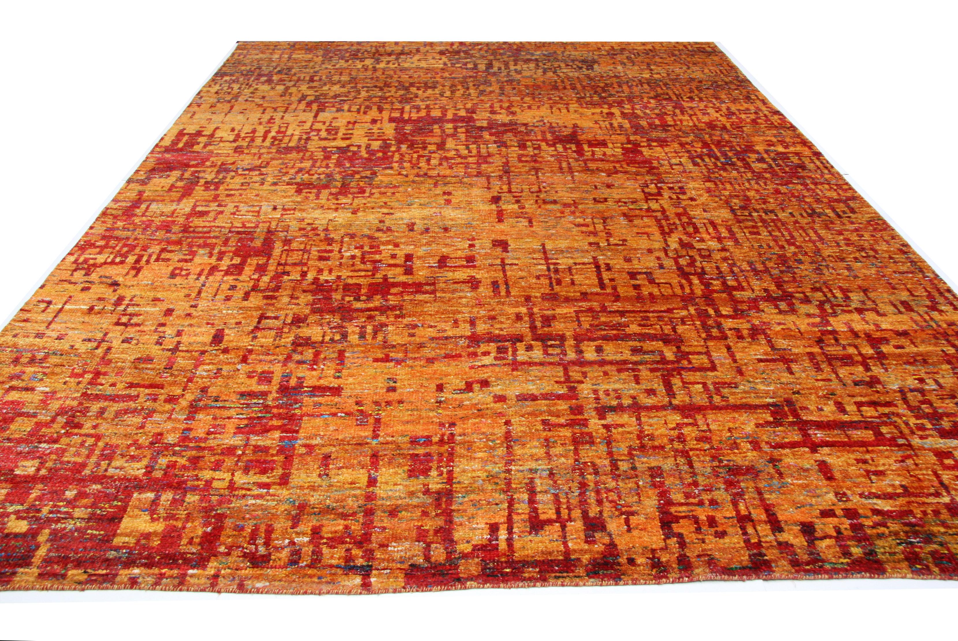 One of Aga John's most popular contemporary designs. Bold tones of orange, gold and red combine to bring a color pop to your space. Hand knotted viscose gives a silky smooth feel to the touch. Handmade in India.

Multiple sizes available. Also