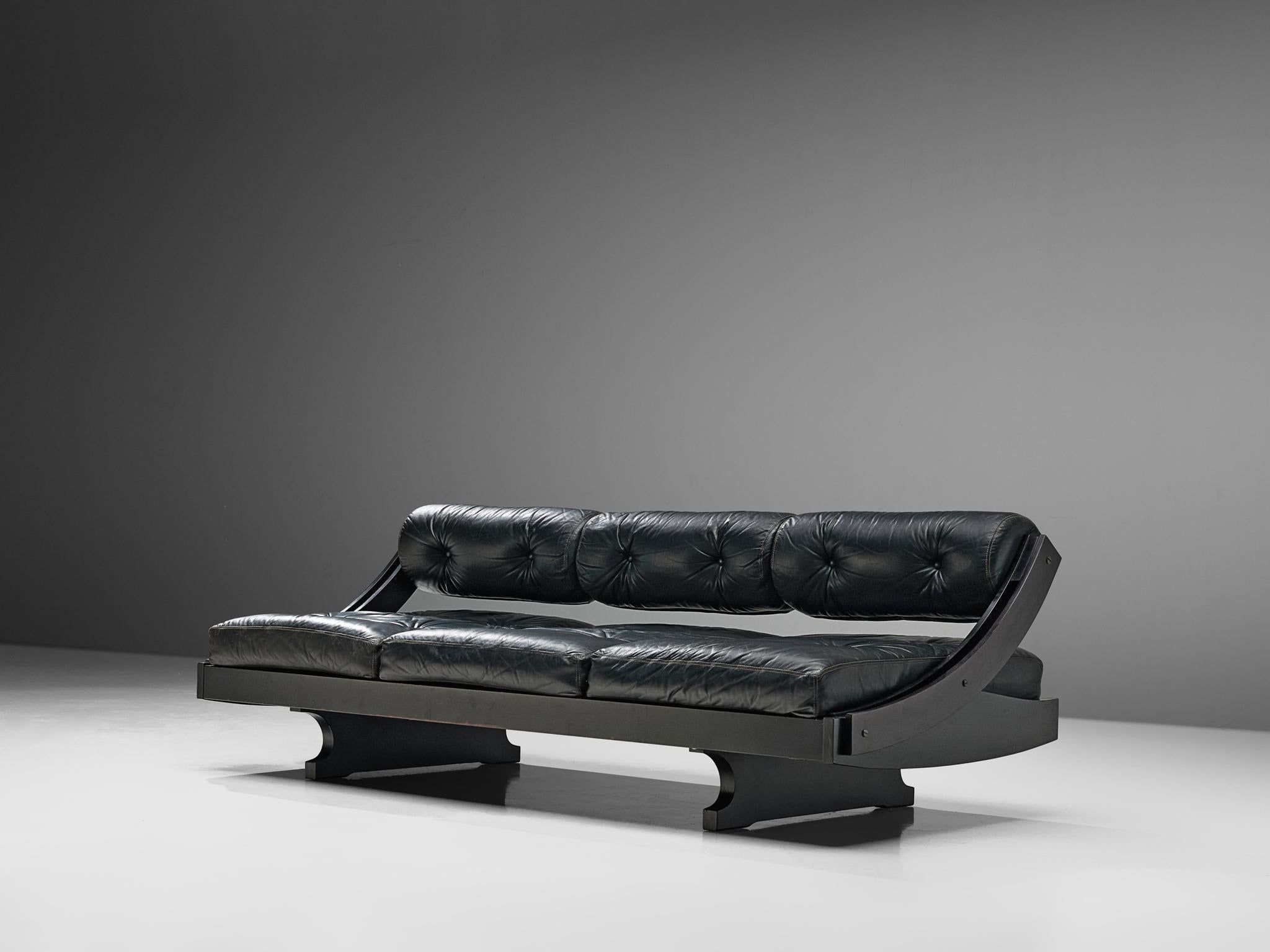 GS-195 sofa designed by Gianni Songia for Sormani, leather and lacquered wood, Italy, 1963.

Very elegant and organic frame with lush cushions upholstered in black leather. The sofa could be converted into a daybed via a sliding back rest. This back