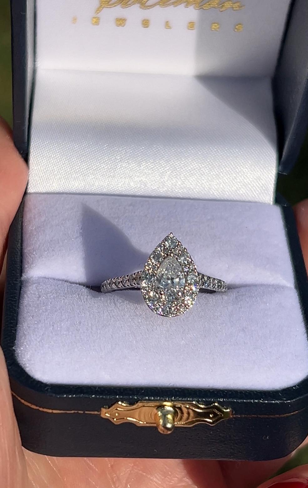 One 14 karat white gold halo pear shaped cluster ring set with one GIA certified pear shaped mined diamond approximately 0.50 carat G color and VS2 clarity. The ring is also set with seventy-six (76) round brilliant cut diamonds approximately 0.50