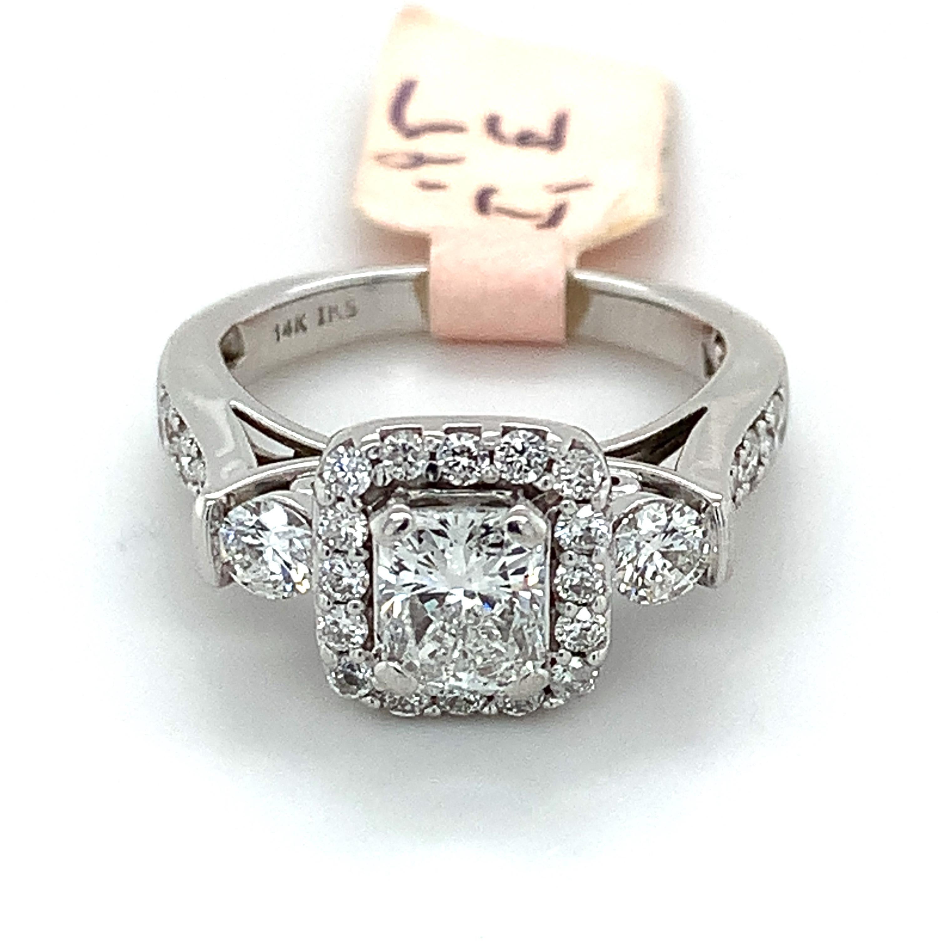 14k White Gold White Radiant Cut Diamond 3 Stone Ring
Size 5
5.1 Grams
1 Radiant Cut Diamond 0.95 Carats
Color: E Clarity: i1
Round Brilliant Cut Diamonds 0.75 Carats Total Weight 
0.75 Carats Total Weight
Color: E-I
Clarity: I1
this is a timeless