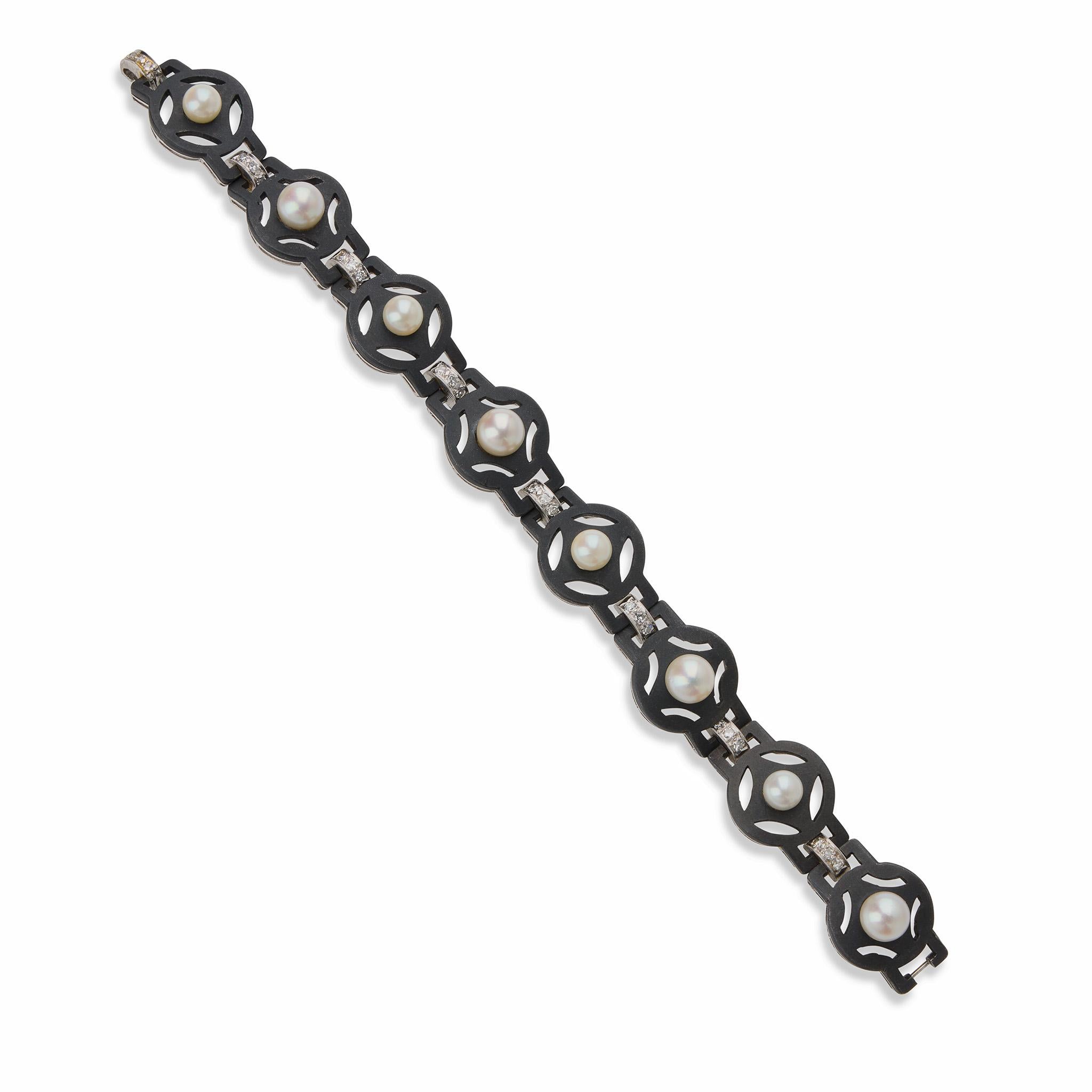 Designed and created by G.T. Marsh & Co. of San Francisco, circa the 1930s-1950s, this blued steel bracelet is set with cultured pearls and diamonds. It is designed as a series of alternating circular blackened steel links with stylized motifs