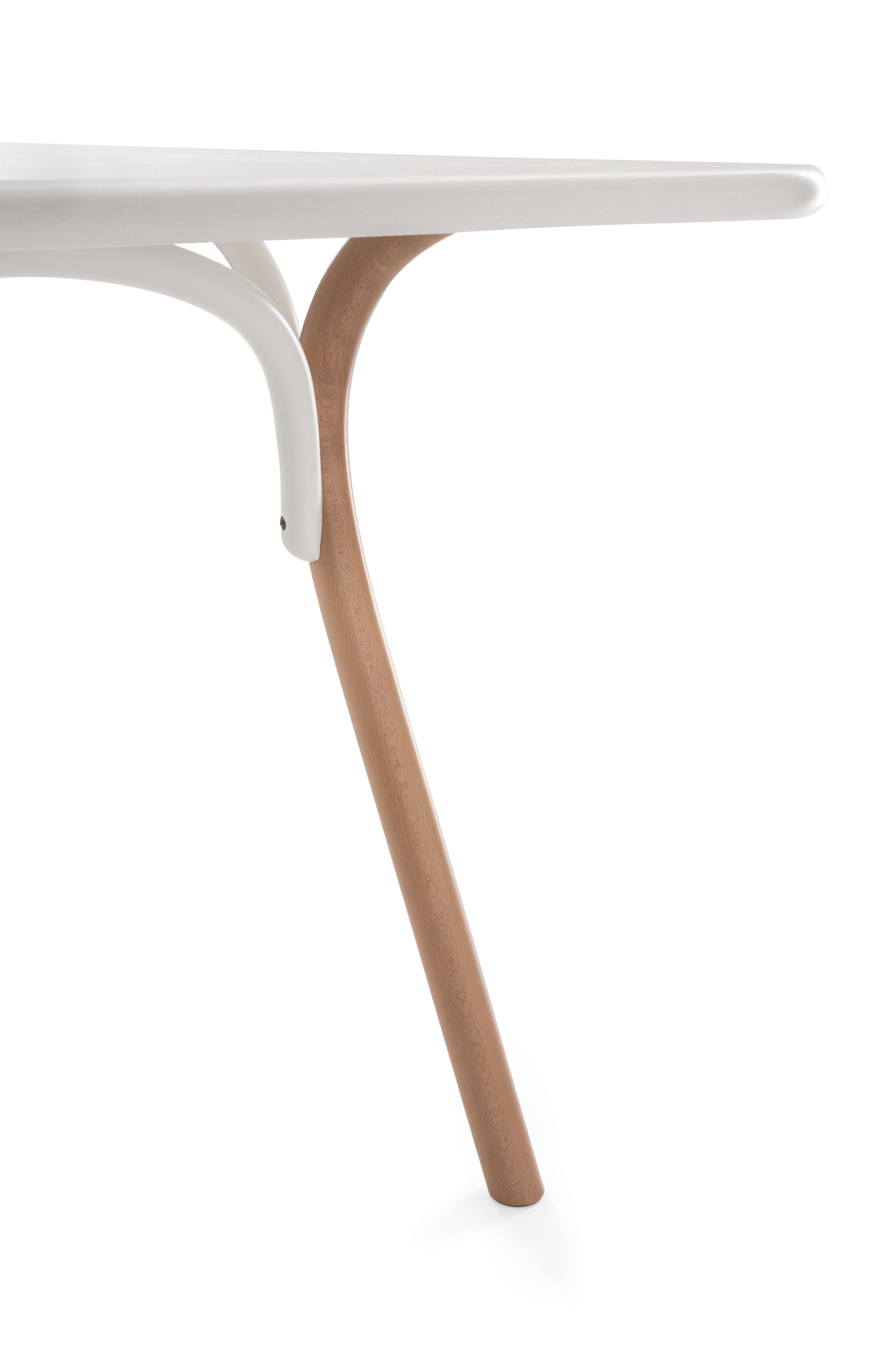 The table, designed by a group of Swedish designers, Front, has a steam bent beech structure, combining its attractive light appearance with the substance of solid wood. The top is made of an ash panel available in two sizes that make the Arch