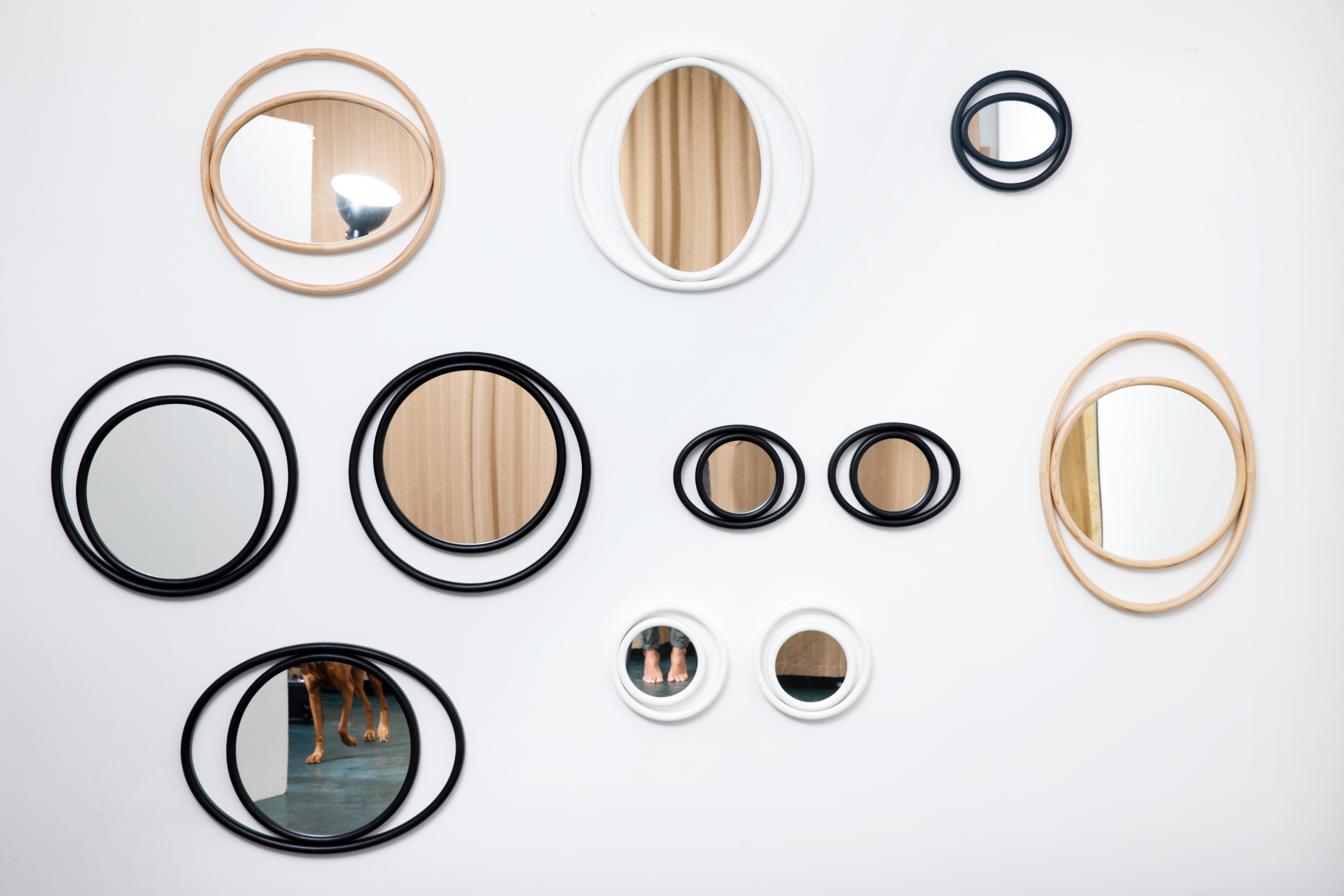 Simple geometric shapes, a combination of circles and ovals, recreate scenic suggestions that bring to mind the mystical powers of the eye and delineate the outline of the EYESHINE mirrors devised by the designer Anki Gneib. The bent ash-wood