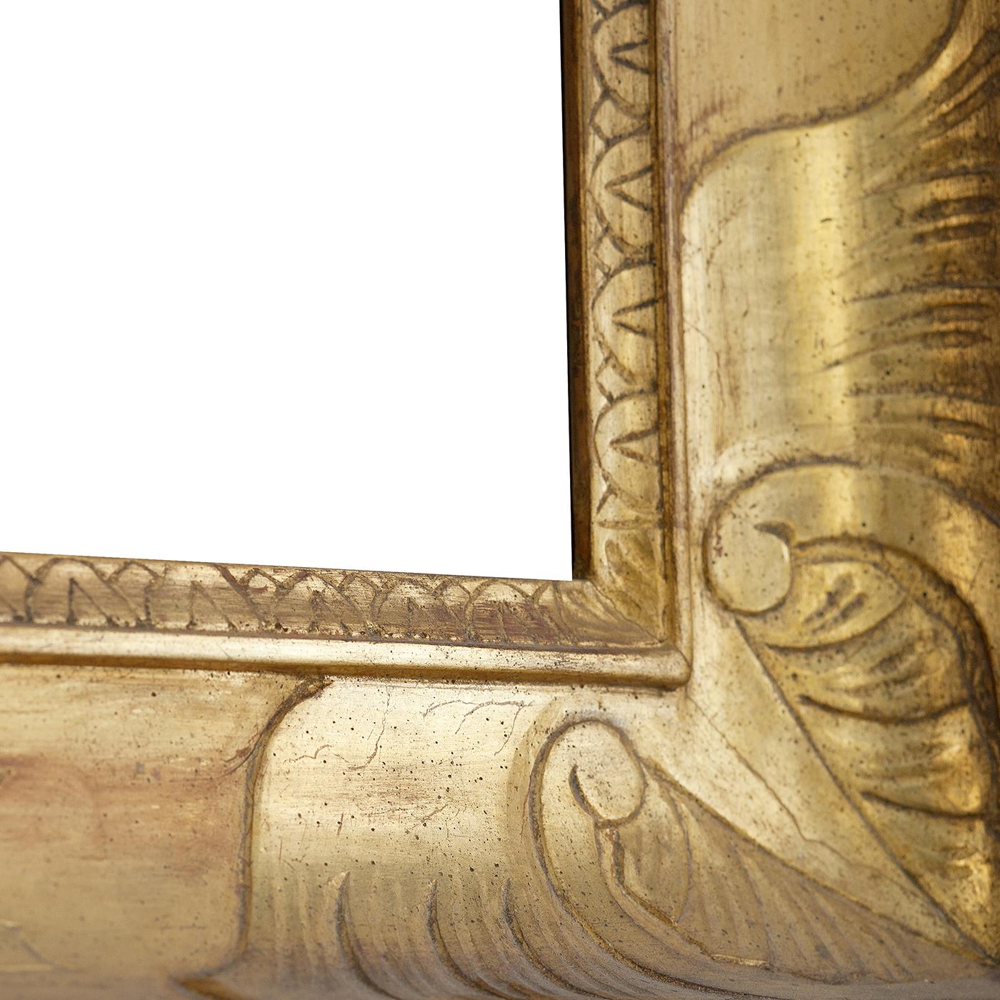 A unique work of craftsmanship that combines art and design, this magnificent mirror of Empire style is painted in luminous and precious gold with the gouache technique and entirely burnished by hand enhancing its engraved details. Precious and