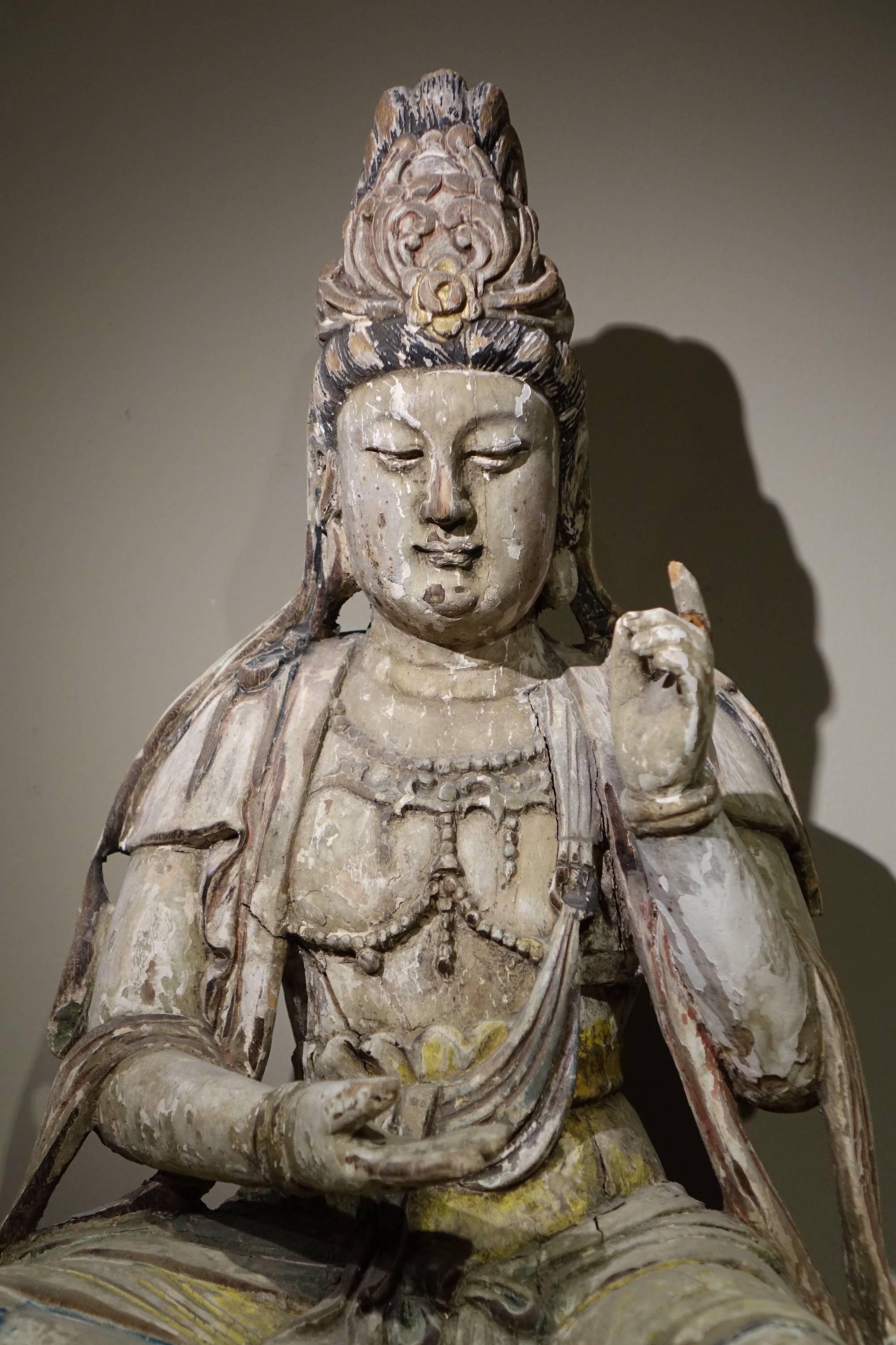 Guanyin, the Chinese form of the Bodhisattva, often depicted as feminine and assimilated to the goddess of compassion.
Polychrome wood, small crinkles in the wood; 
Ming style, China, 19th century.