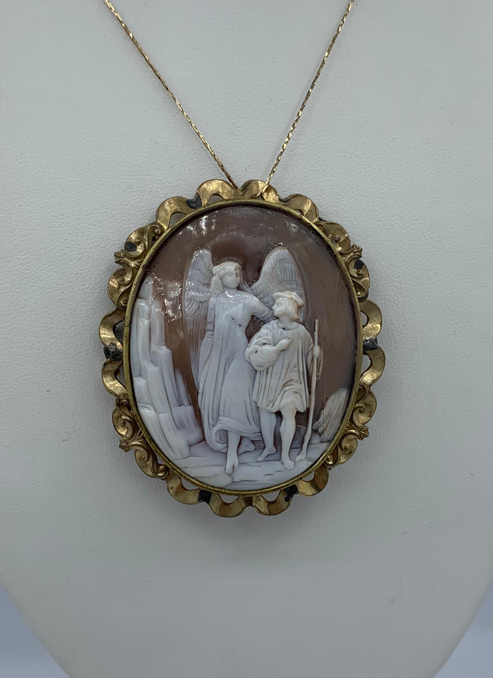 This is an absolutely stunning and very rare large 2.5 inch tall antique Victorian - Belle Epoque Shell Cameo Pendant Brooch Pin with a hand carved image of a Guardian Angel with Child walking on a mountain top set in a beautiful scrolling