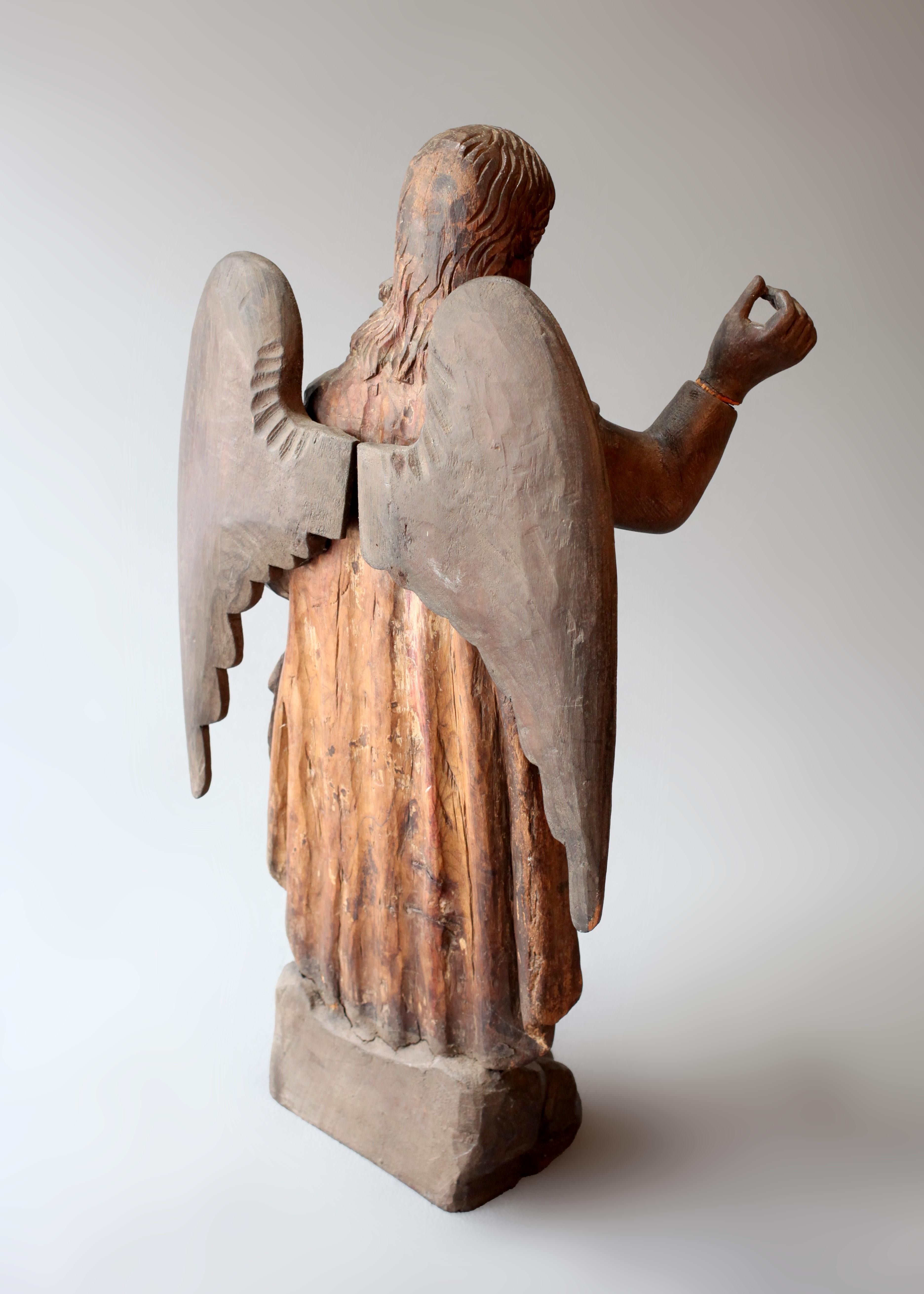 Symbolism and craftsmanship aside, this Guatemalan Carved Wood Altar Figure of the Angel Gabriel from the 18th century holds within it an immense energy of historical significance. Altar figures were purposeful objects of devotional connection,