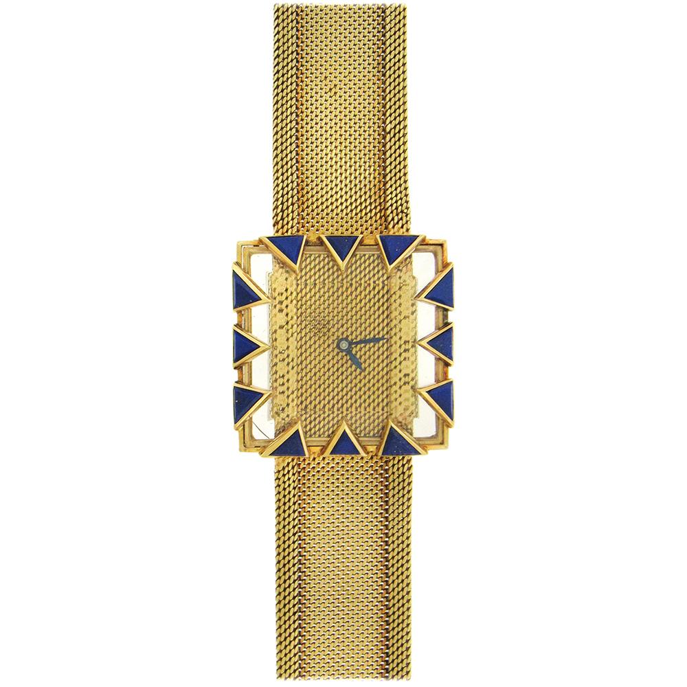 From Swiss maker Gubelin, a 1960's highly stylized 18K gold and lapis lazuli bracelet watch.  The 32mm x 32mm square case with extended crystal features triangular lapis claw-like openwork bezel. The woven mesh dial echoes the woven mesh bracelet