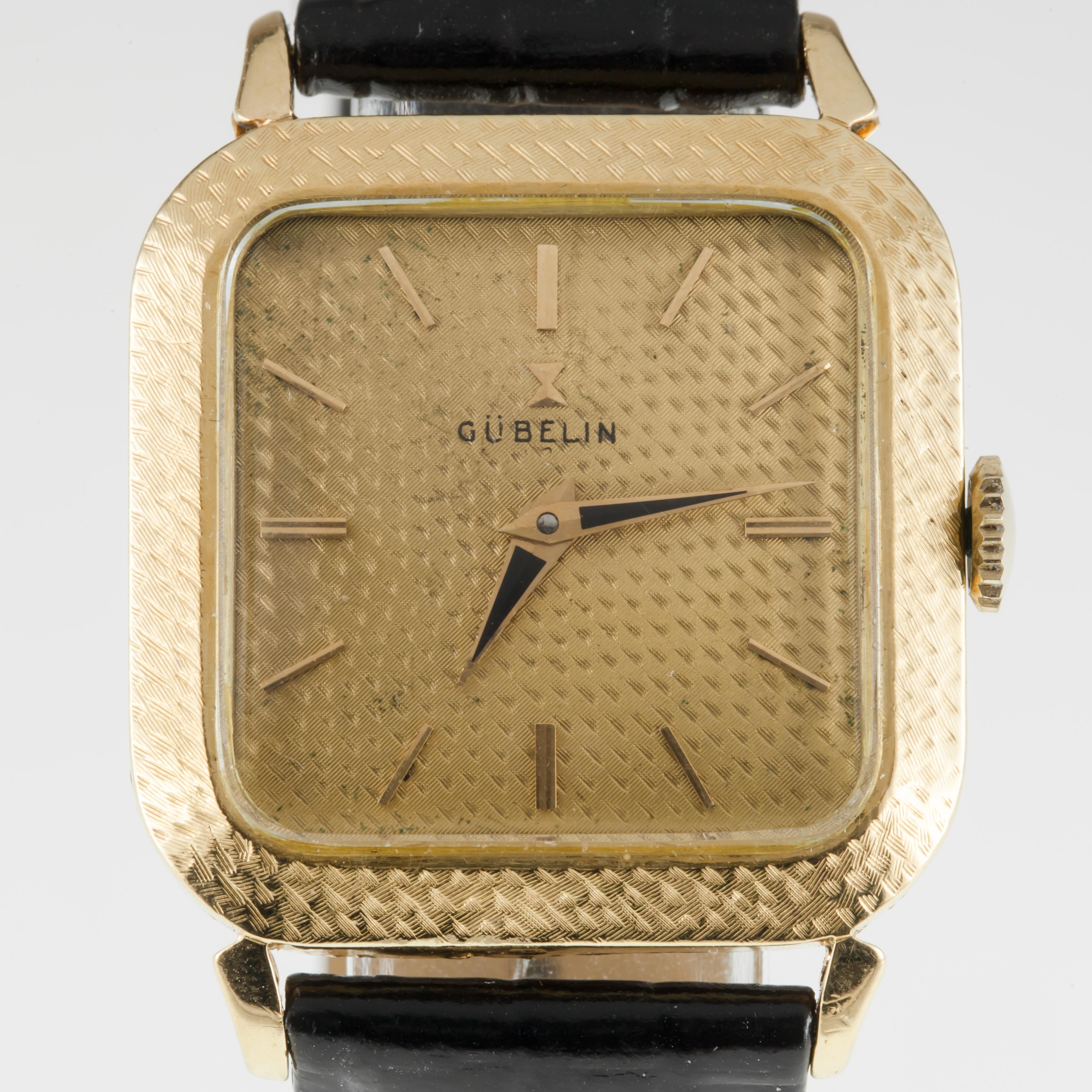 Gubelin 18k Yellow Gold Men's Hand-Winding Watch w/ Leather Band #320
Movement #320
Case #182124
18k Yellow Gold Textured Square Case
29 mm Wide
29 mm Long
Lug-to-Lug Distance = 38 mm
Lug-to-Lug Width = 19 mm
Thickness = 7 mm
Gold Dial w/ Gold Hands