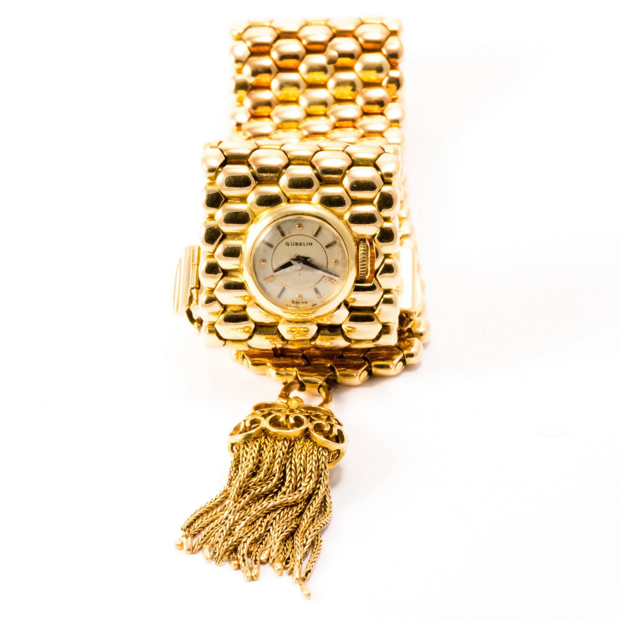 Very elegant and eye-catching this beautiful bracelet made in yellow gold conceals a round watch dial, revealed  by a simple twist of the wrist. Texture, clasp and tessel make this bracelet a very enjoyable jewel to wear for a life time.
The