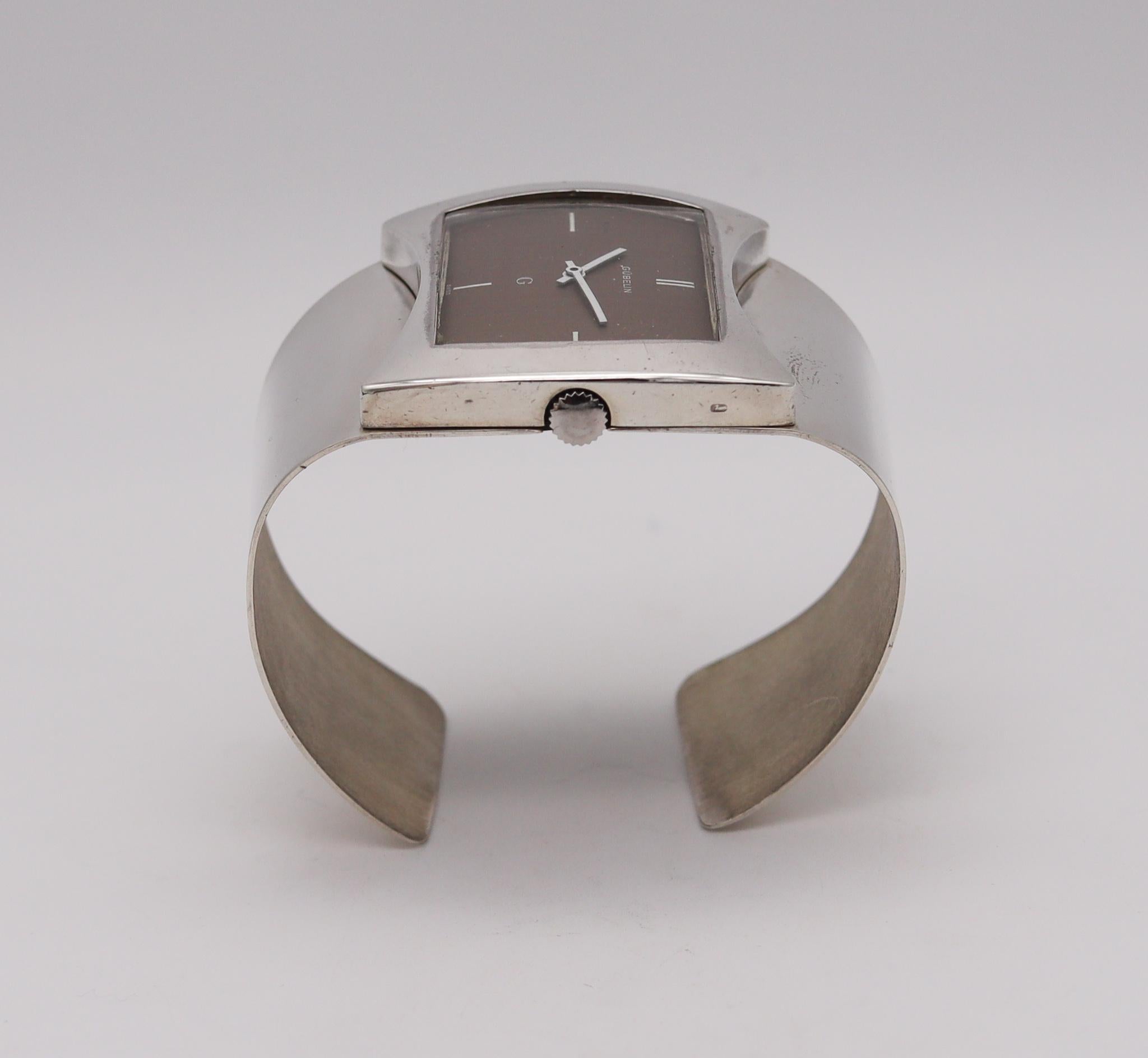 A retro wrist watch cuff designed by Gubelin.

Beautiful vintage cuff bracelet wristwatch, created in Zurich, Switzerland by the house of Gubelin, back in the 1973. This sculptural retro piece was part of the Lady G collection and has been crafted