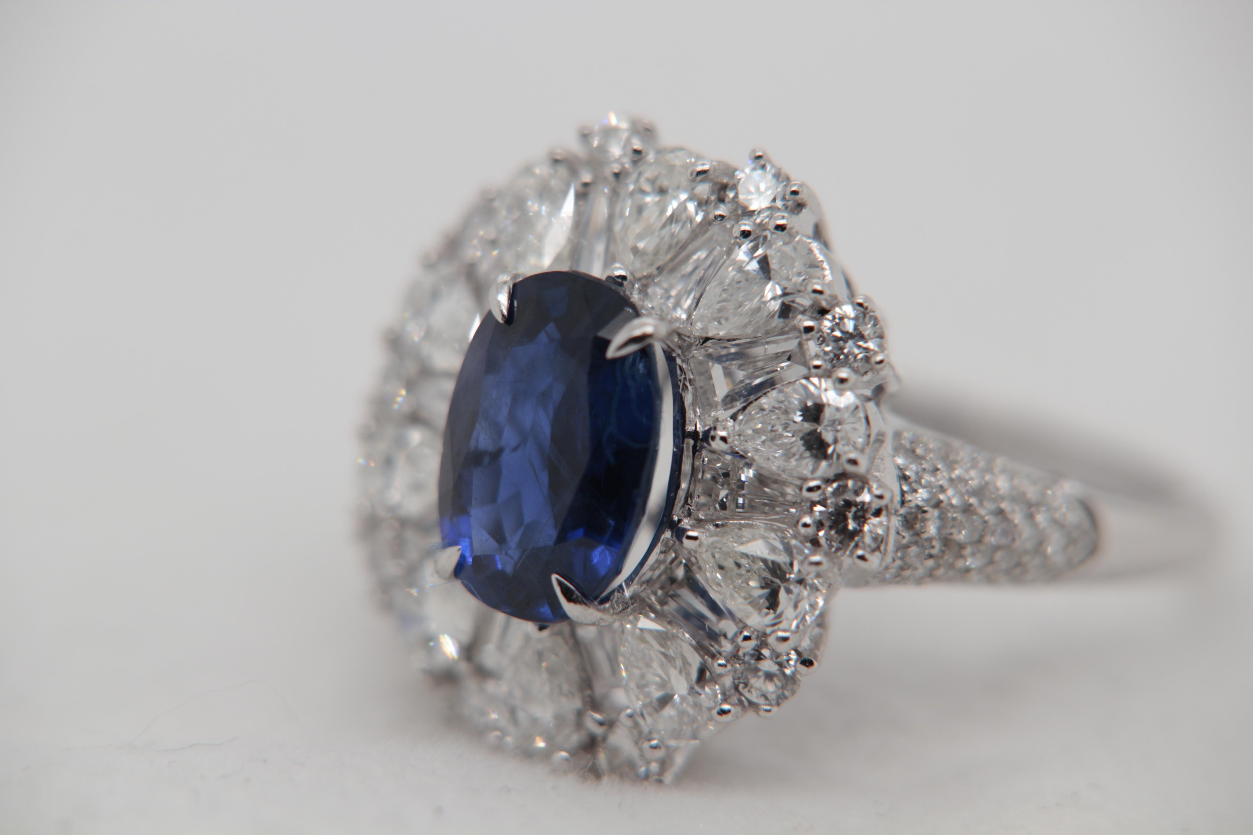A brand new 3.01 carat Burmese Blue sapphire ring mounted with diamonds in 18 Karat gold. The blue sapphire weighs 3.01 carat and is certified by Gubelin Gemlab as natural, no heat, and Blue. The total diamond weight is 2.65 carat and the total