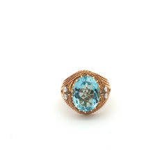 Gübelin aquamarine, 7.00 ct, set in a braided 18k gold ring.