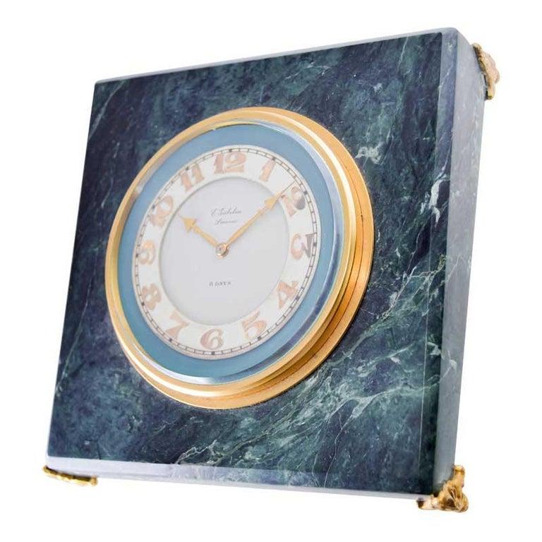 FACTORY / HOUSE: House of Gubelin
STYLE / REFERENCE: Art Deco Flat Table Clock 
METAL / MATERIAL: Stone and Gilt Brass
CIRCA / YEAR: 1930's
DIMENSIONS / SIZE:  Length 5