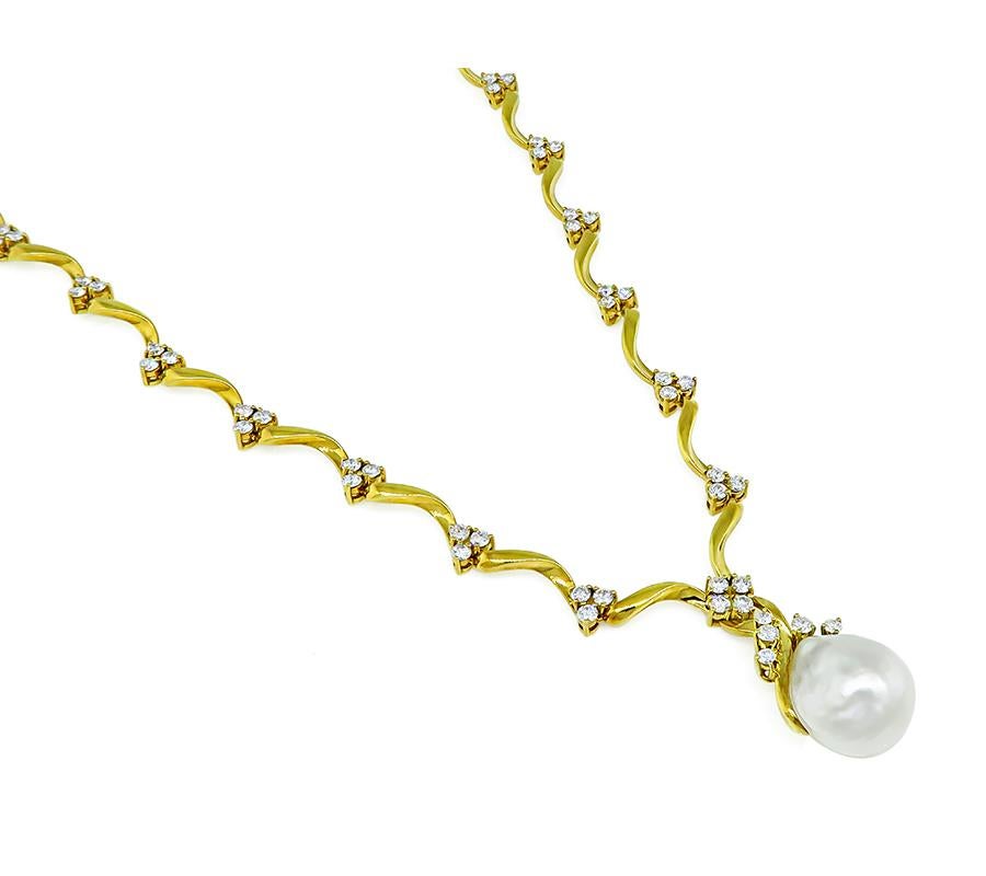 This is an elegant 18k yellow gold necklace by Gubelin. The necklace is centered with a lovely baroque pearl. The pearl is accentuated by sparkling round cut diamonds that weigh approximately 6.00ct. The color of these diamonds is E-F with VS