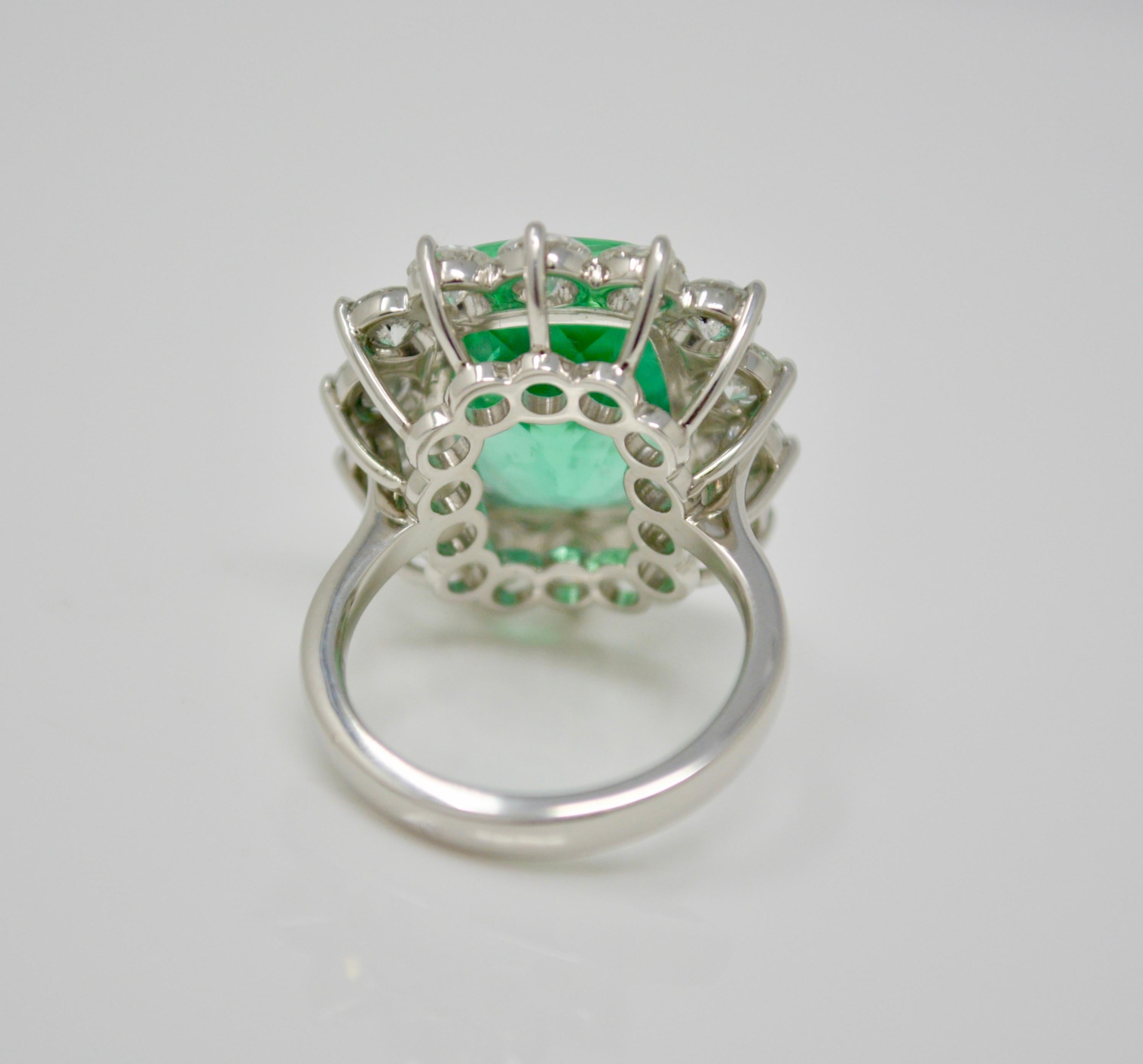 This unique creation by Moguldiam Inc features a Gubelin certified 10.76 carat columbian cushion shaped luscious green emerald surrounded by  beautiful white circular cut diamonds. This is a beautiful and vibrant  columbian emerald. The fourteen