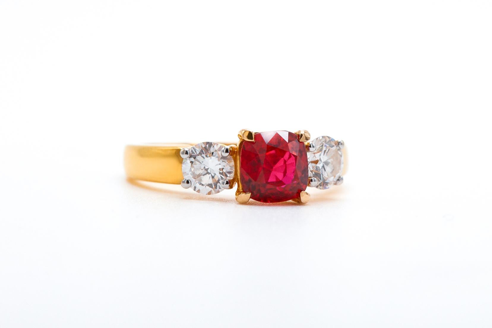 18K YELLOW GOLD 
2 IF, D COLOR GIA CERTIFIED DIAMONDS  0.83 CARATS
1 NO-HEAT PIGEON BLOOD BURMESE RUBY  1.72 CARATS
GUBELIN LAB CERTIFIED  PIGEON BLOOD RED

Introducing our mesmerizing 1.72 carat Burmese Cushion Shaped Ruby Ring, embodying boldness