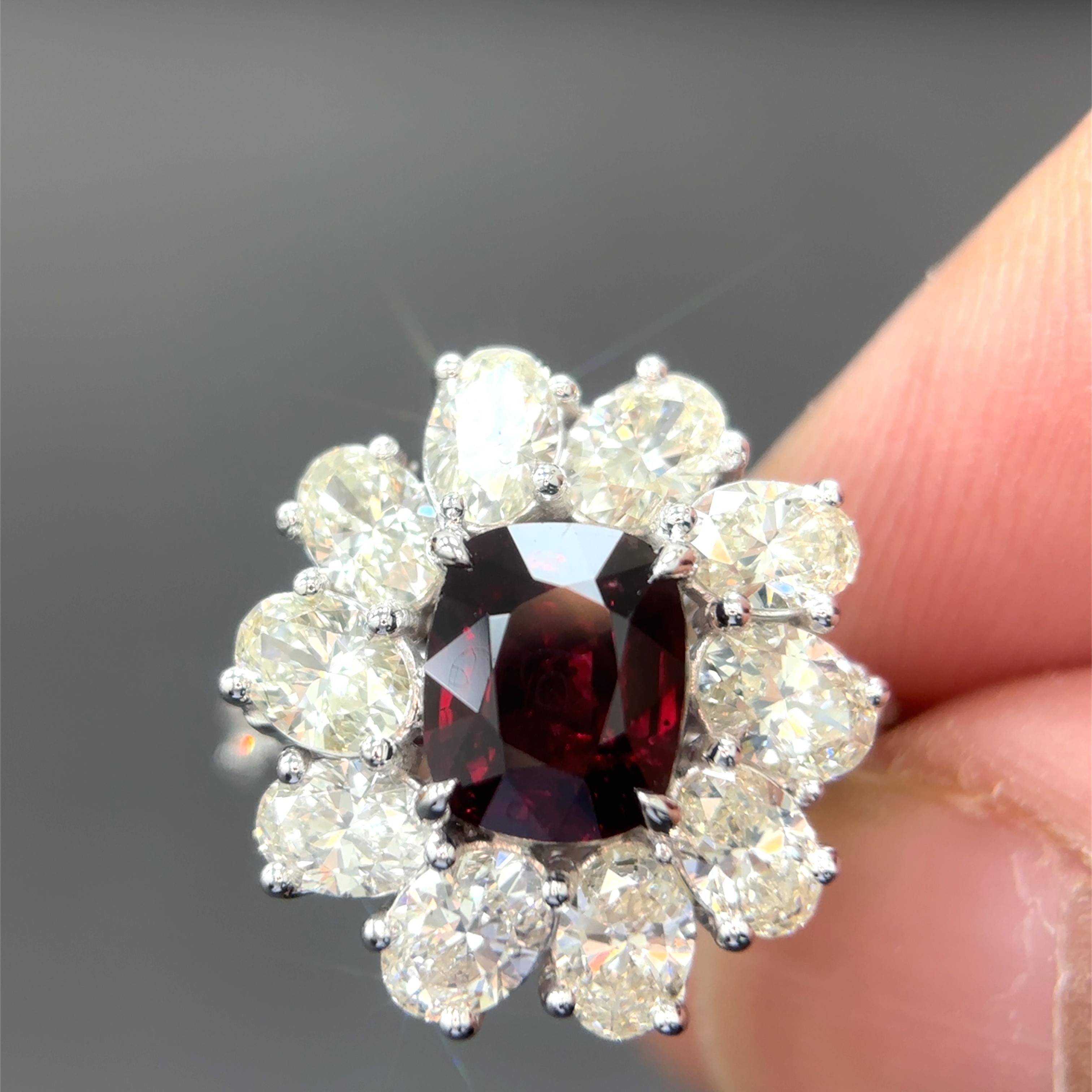 A beautiful creation, it features a rare 2.03 carat Burmese natural ruby, spared of any treatment whatsoever, surrounded by high quality natural white oval cut diamonds.

Certified by Gubelin Gem Lab, the ruby is fashioned as a cushion-cut, hailing