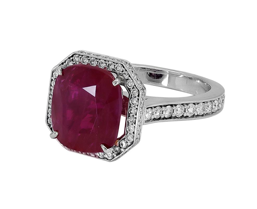 Showcasing a vibrant no heat cushion cut diamond surrounded by a single row of round brilliant diamonds. Set in a polished platinum mounting accented with diamonds.
Ruby weighs 5.63 carats and is certified by Gubelin as Burmese origin with no